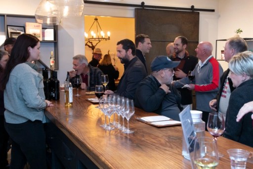 A candid moment among guests at Twisted Roots Winery during Sip, Savor, & Salute