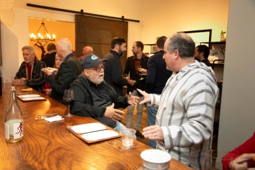 Guests raising a toast at the Sip, Savor, & Salute Veterans Day weekend fundraiser