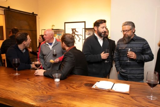 A candid moment among guests at Twisted Roots Winery during Sip, Savor, & Salute