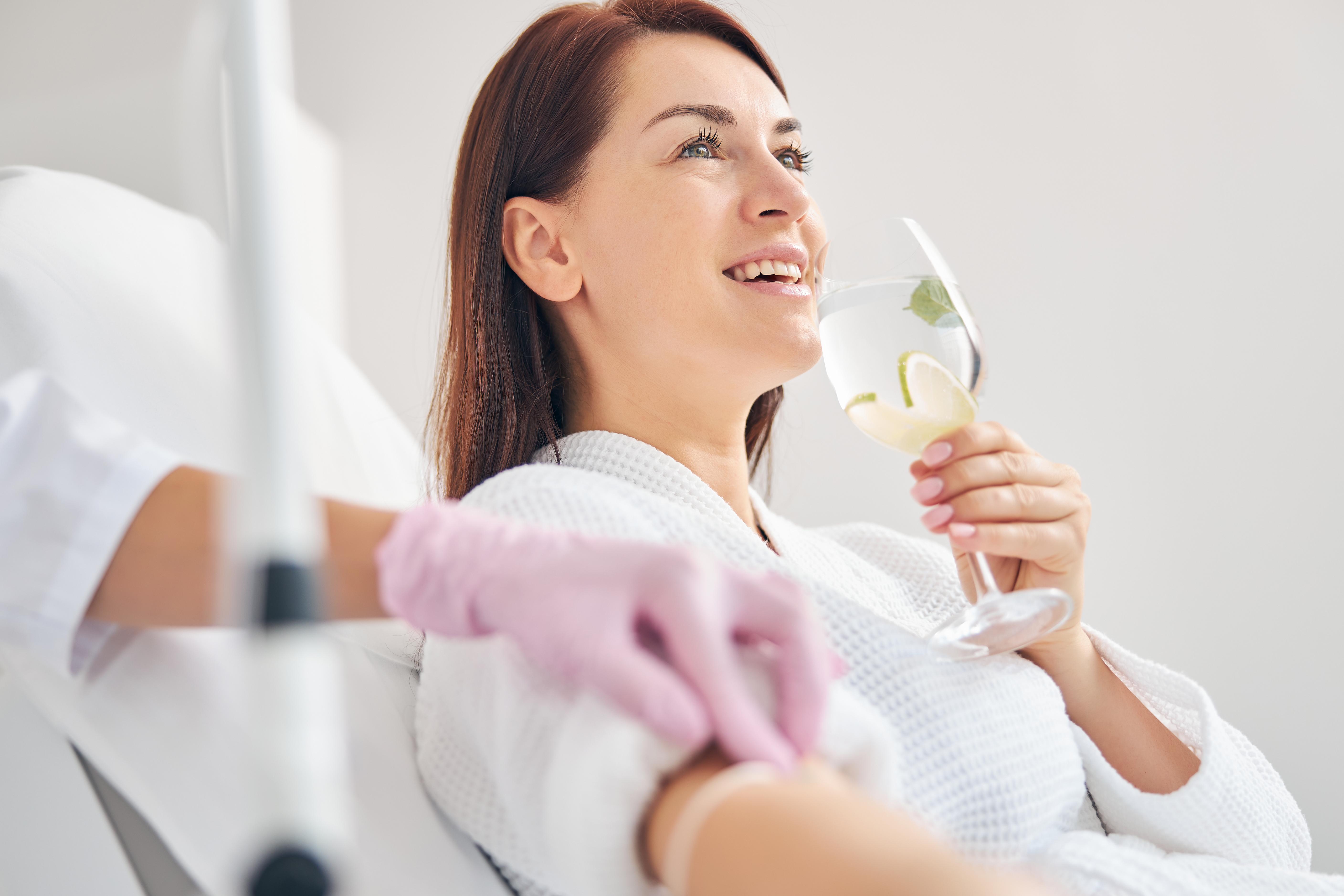Female patient receiving youth plasma in medical setting.