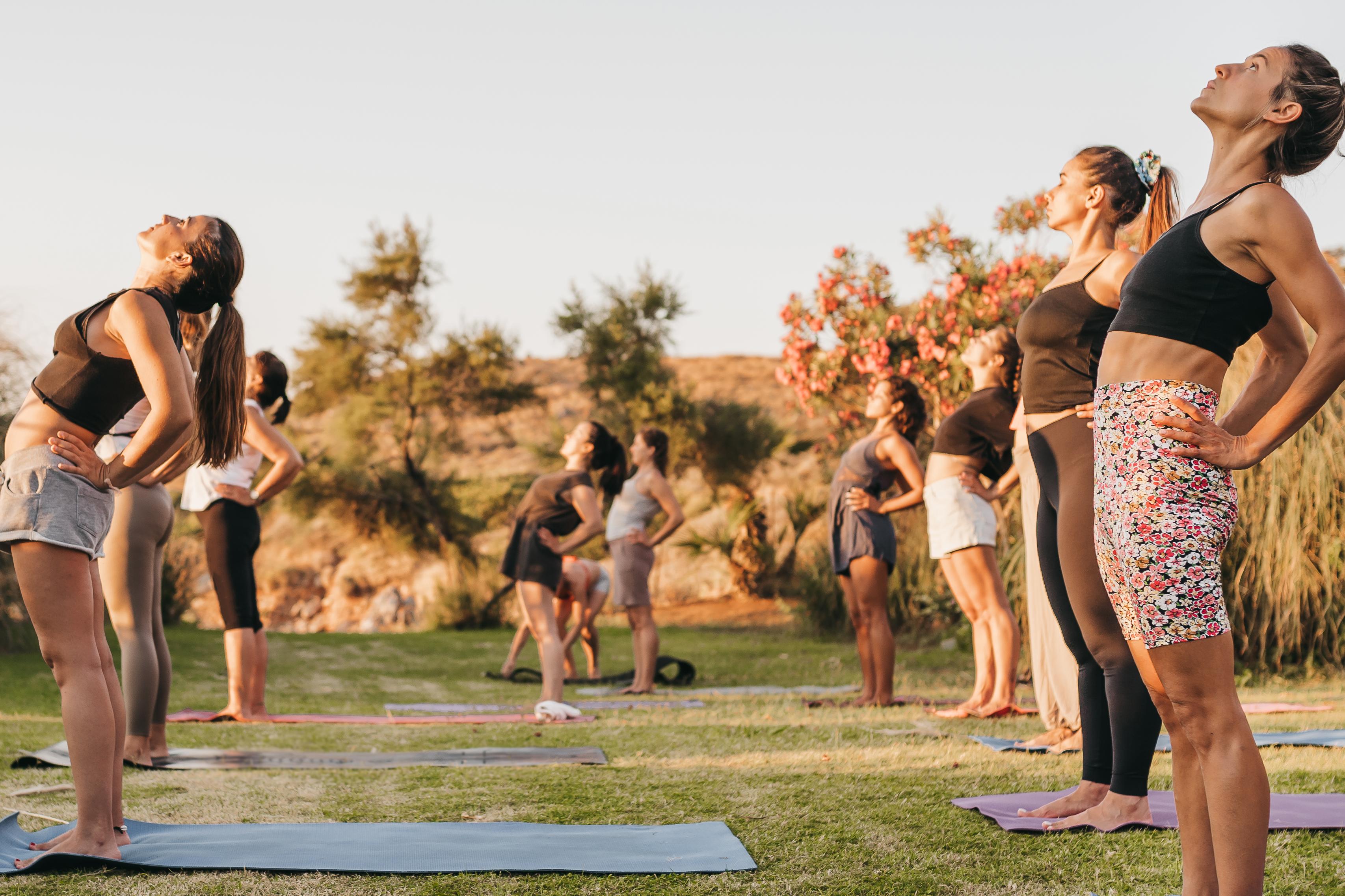 A group of women practicing yoga outdoors
