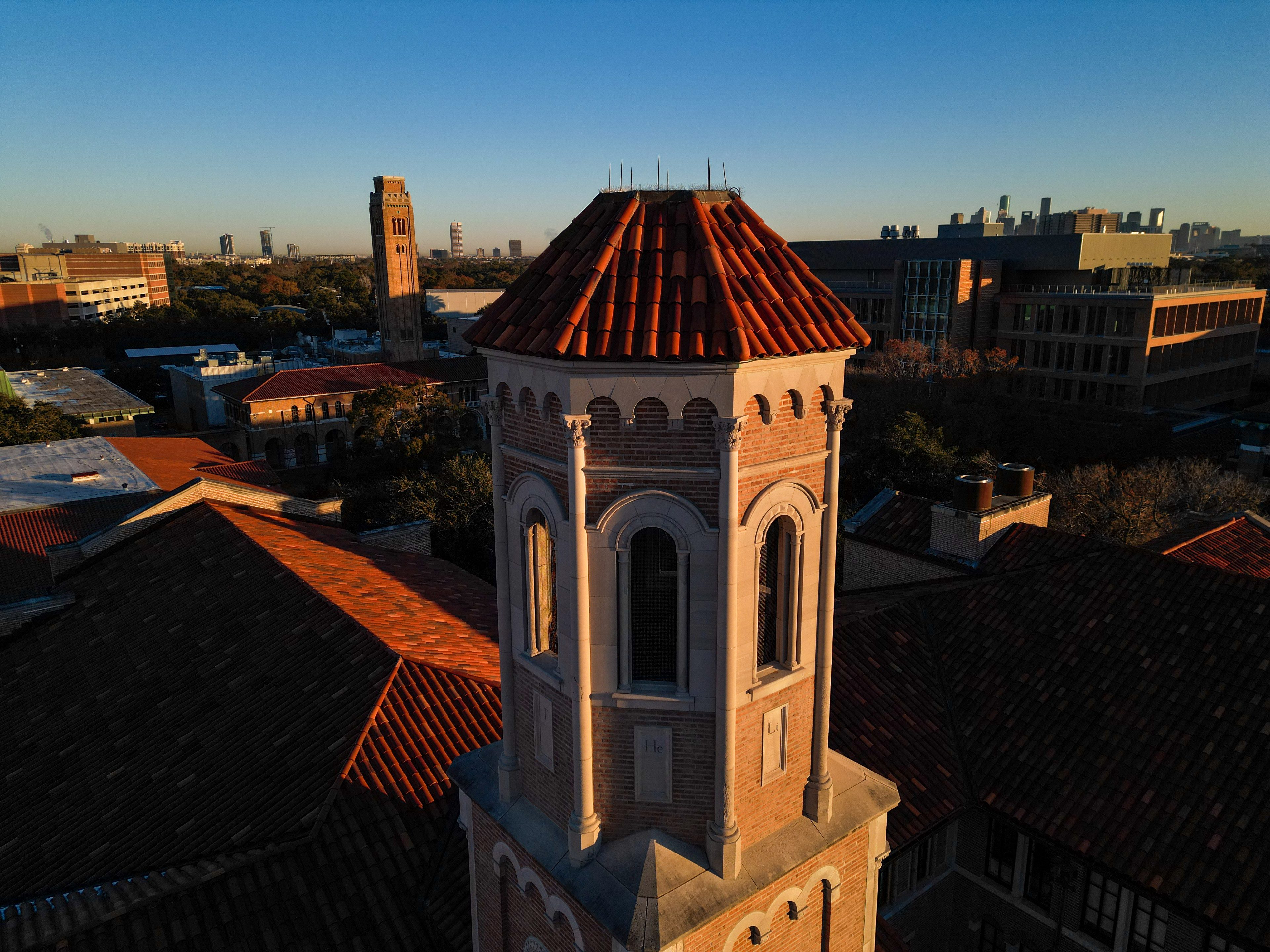 Rice University campus at sunrise, with the Houston skyline in the distance