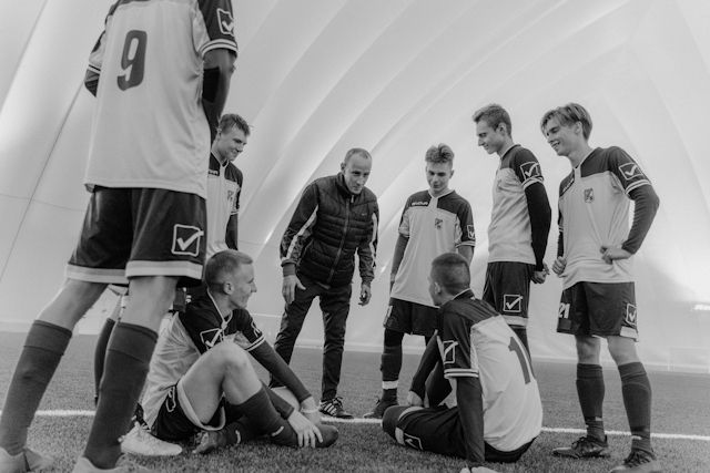 sportler sitzen sportler stehen im kreis sportwart