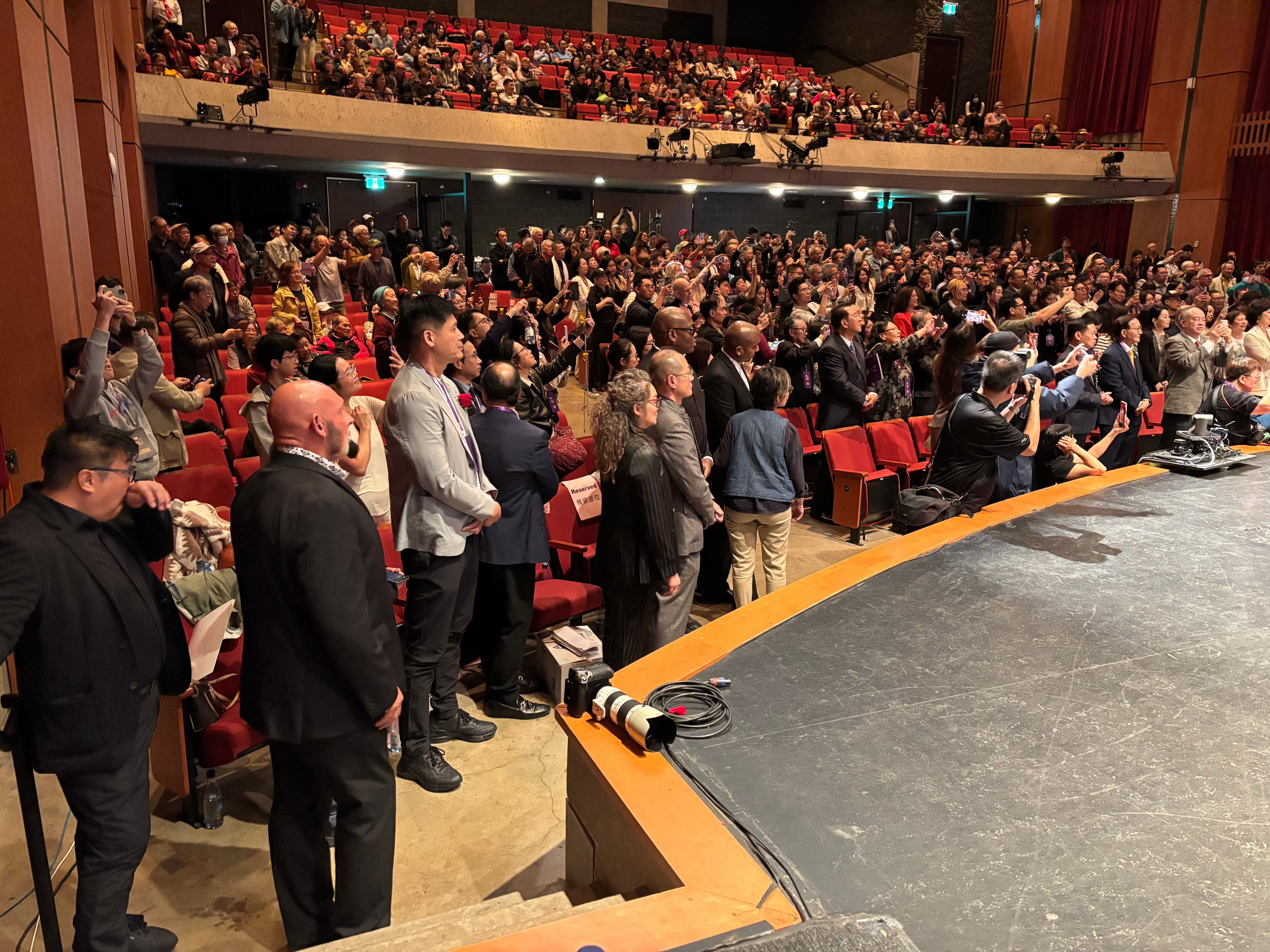 A full house rises to its feet inside the festival theatre