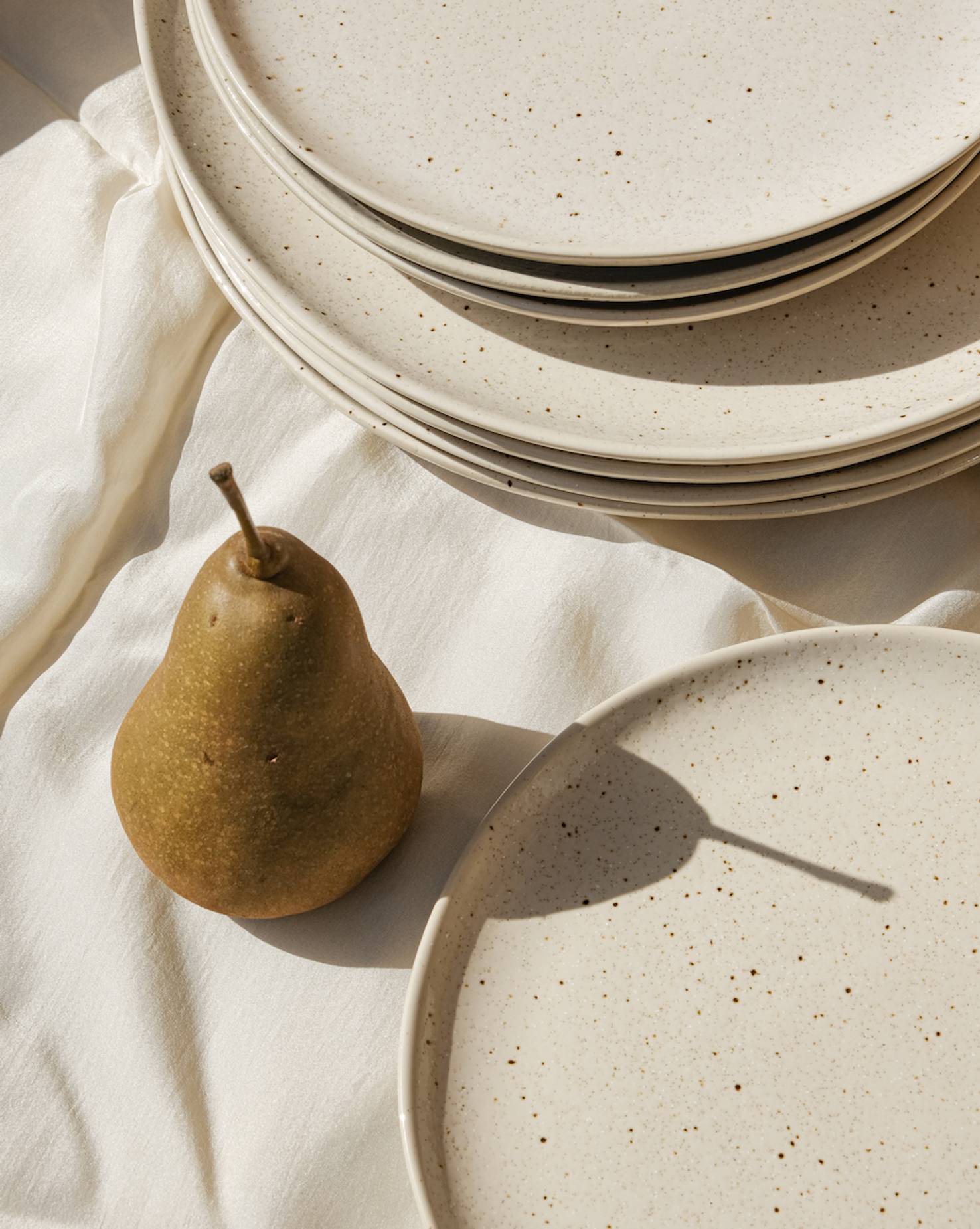 Brand identity image for OS Benefits showing a pear and plates, evoking the dining and hospitality sector the platform serves.