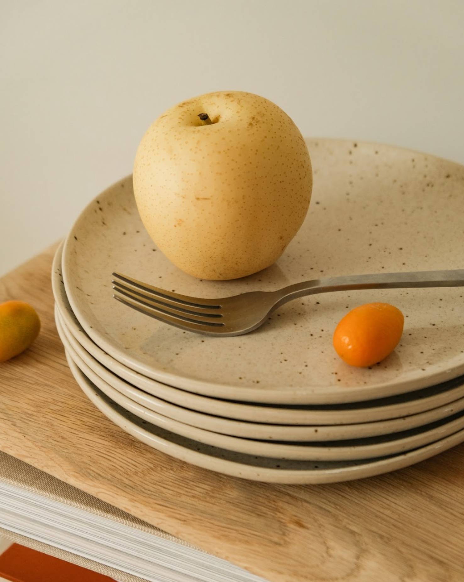 OS Benefits brand identity photograph with an apple and fork on plates, symbolizing the connection to the food service and hospitality industry.