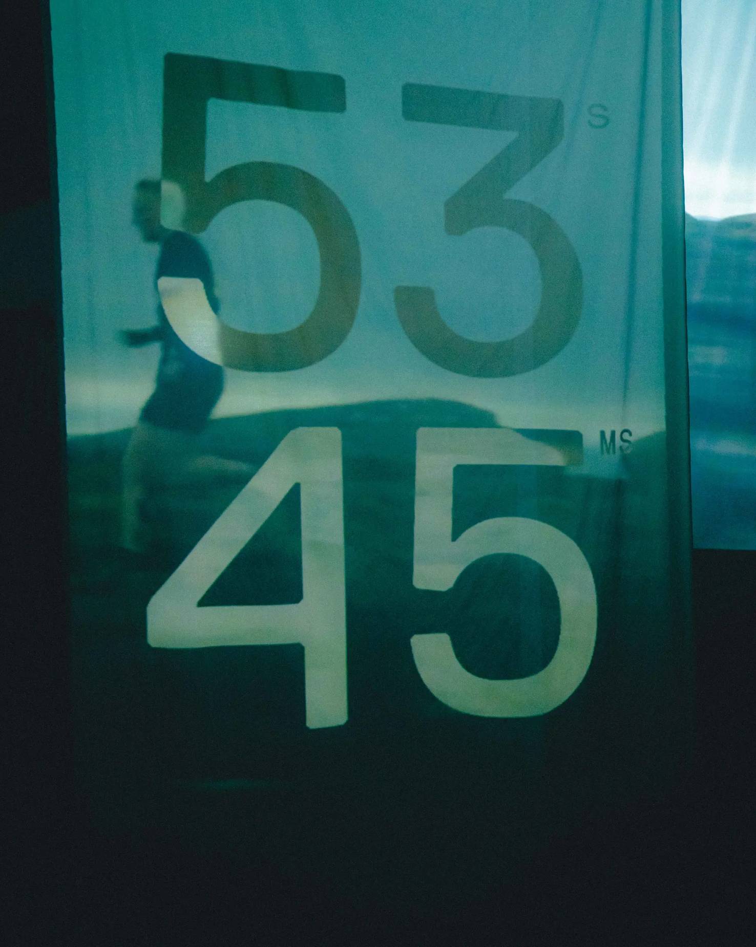 Image from a Pertex event showing numbers projected onto a fabric banner, illustrating innovative ways the brand showcases its technology.