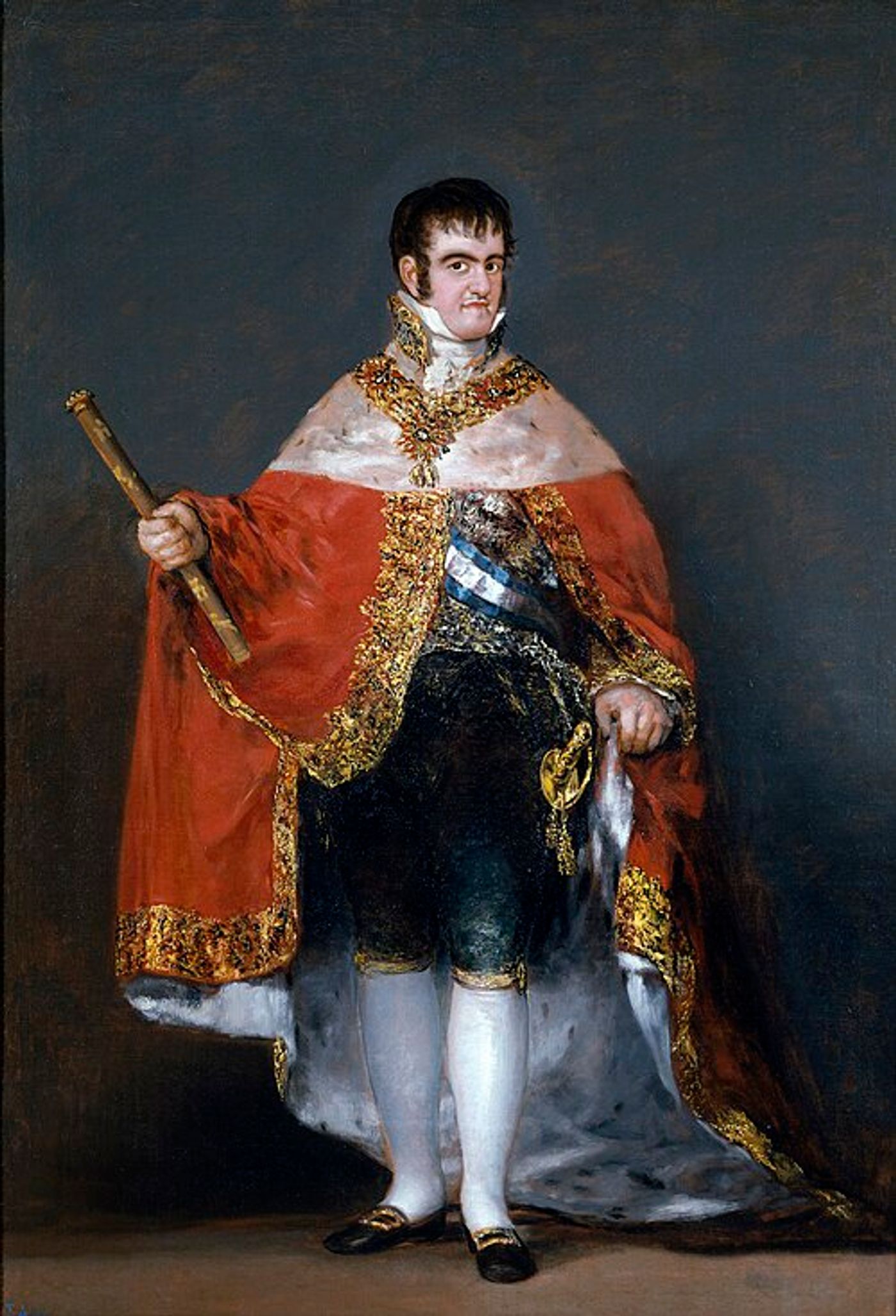 Portrait of a man in royal regalia, wearing a red cape with gold embroidery, holding a staff, wearing a blue sash and formal 19th century Spanish court dress.