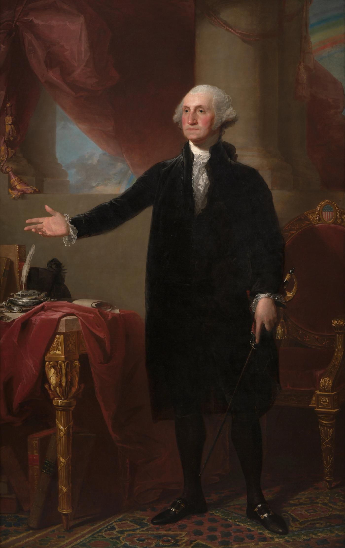 Full-length portrait of George Washington standing in a black velvet suit with his right arm extended, beside a table with books and an inkstand under a red curtain