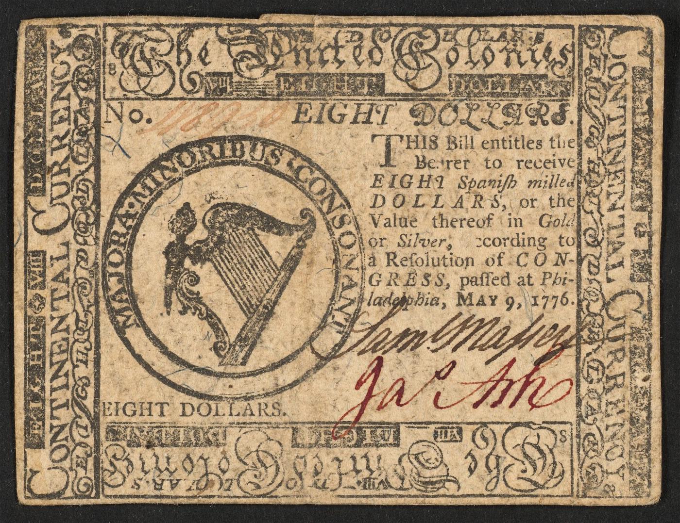 Continental Currency eight-dollar bill headed "The United Colonies," with a harp in a circular seal and handwritten signatures in brown and red ink