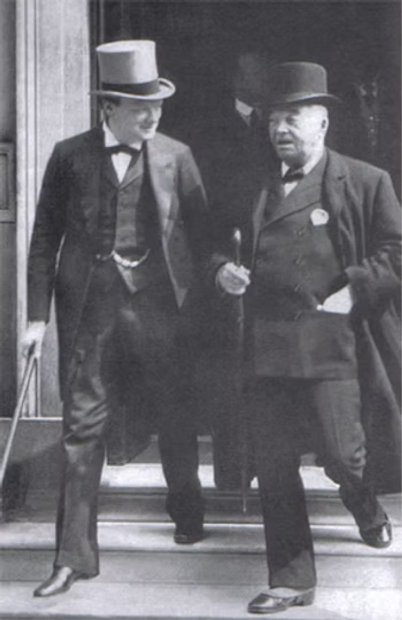 Two men in formal attire with top hats standing outside a building, engaged in conversation.