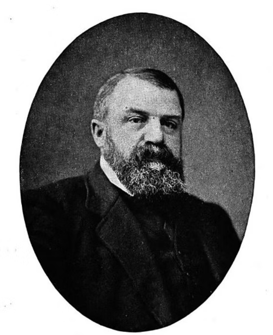 Black and white portrait photograph of a bearded man in formal attire, circa late 19th century.