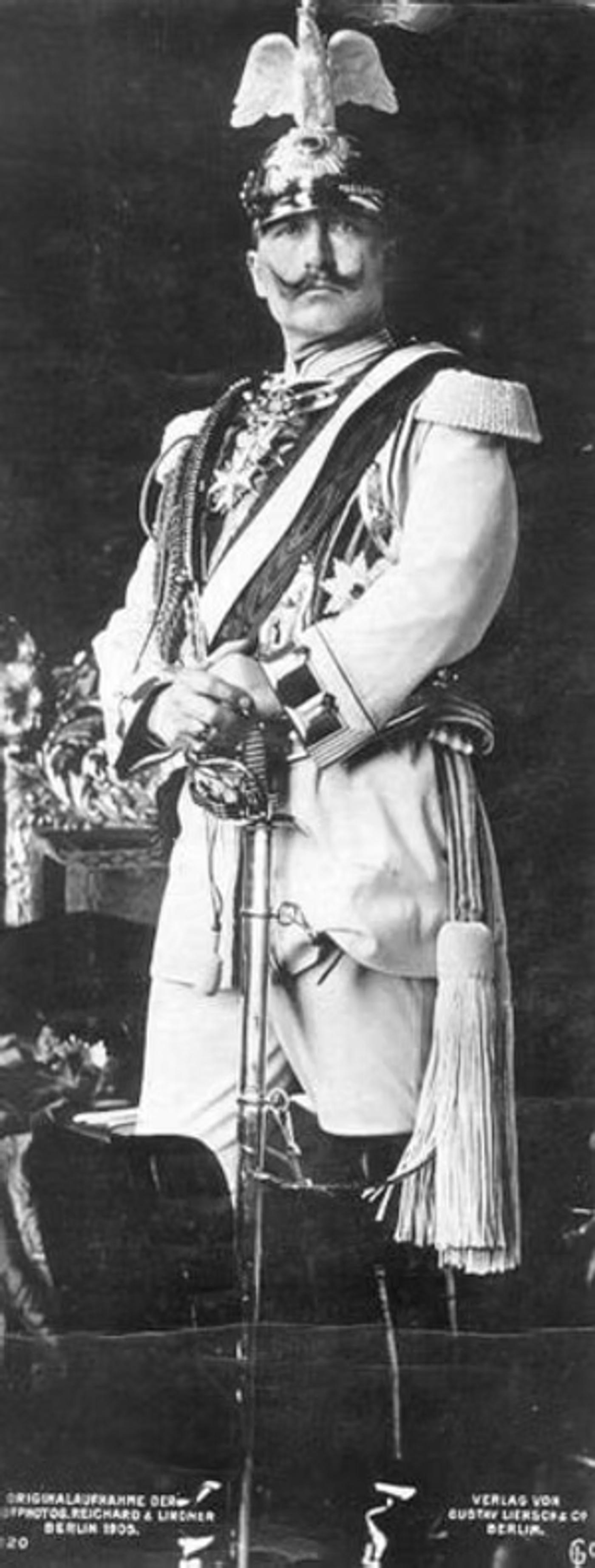 Portrait of Kaiser Wilhelm II: military officer in white uniform with medals, sash, and ceremonial sword, circa 1915.