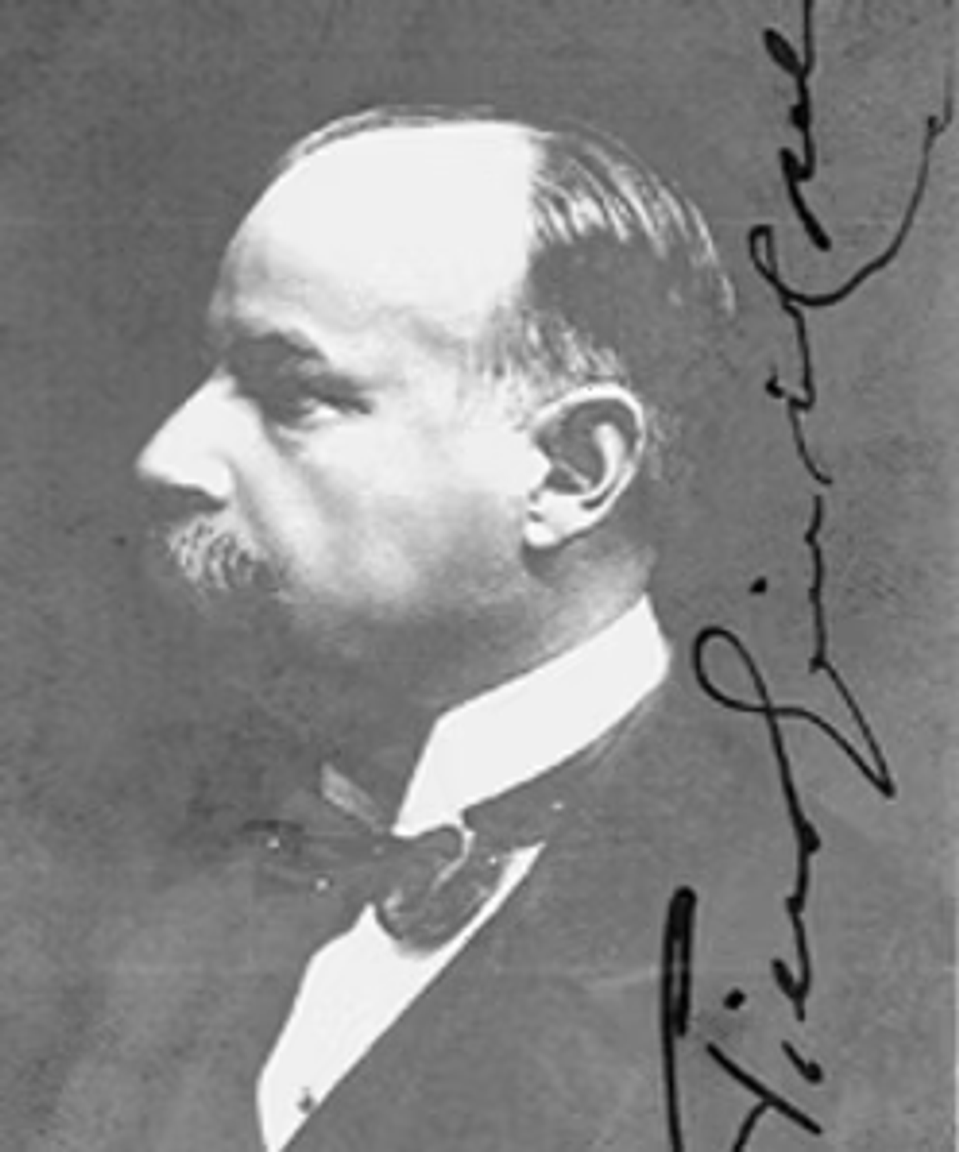 Black and white profile portrait of a bearded man in formal attire with a signature alongside, circa early 1900s.
