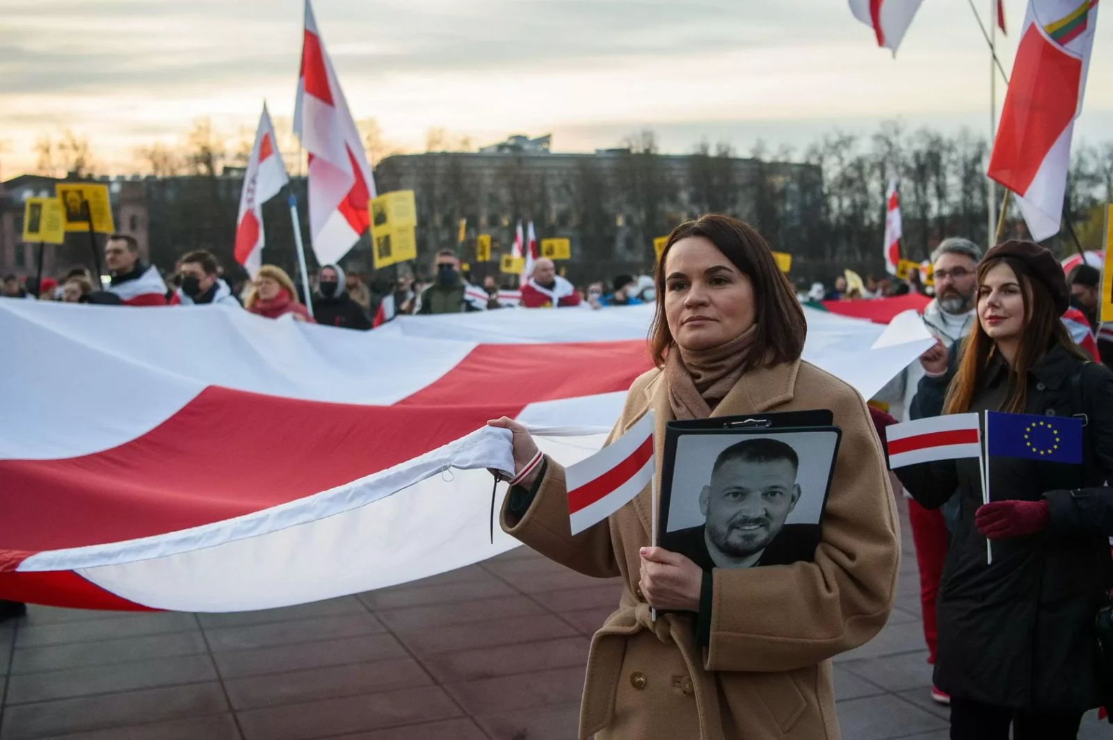 Belarusian national leader Sviatlana Tsikhanouskaya holds a photo of her imprisoned husband as she takes part in rally on 25th March 2025. 
