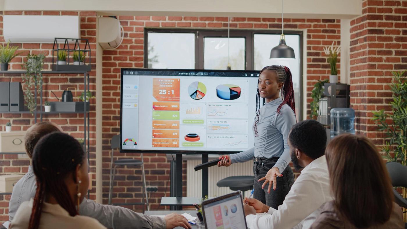 Team of professionals in a boardroom working session around a meeting table