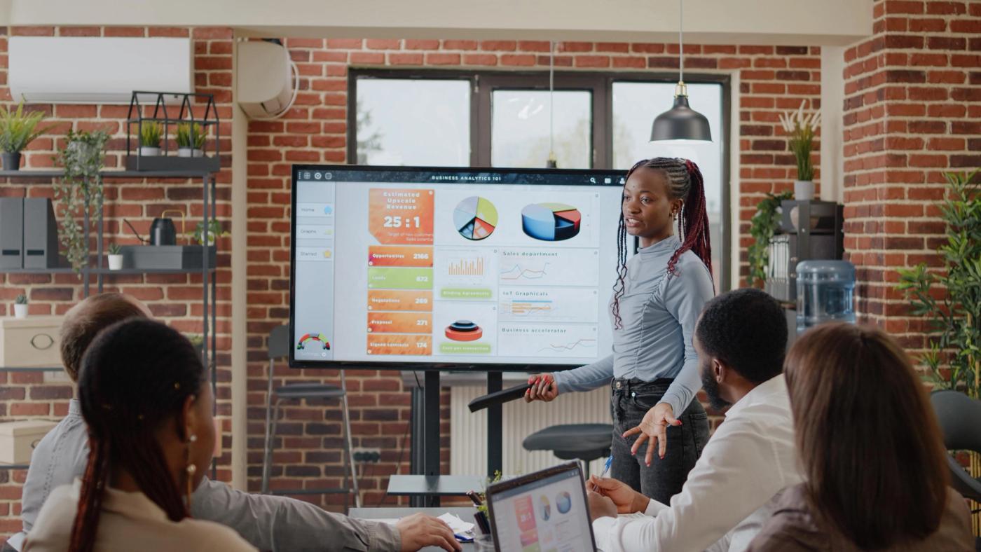 Team of professionals in a boardroom working session around a meeting table