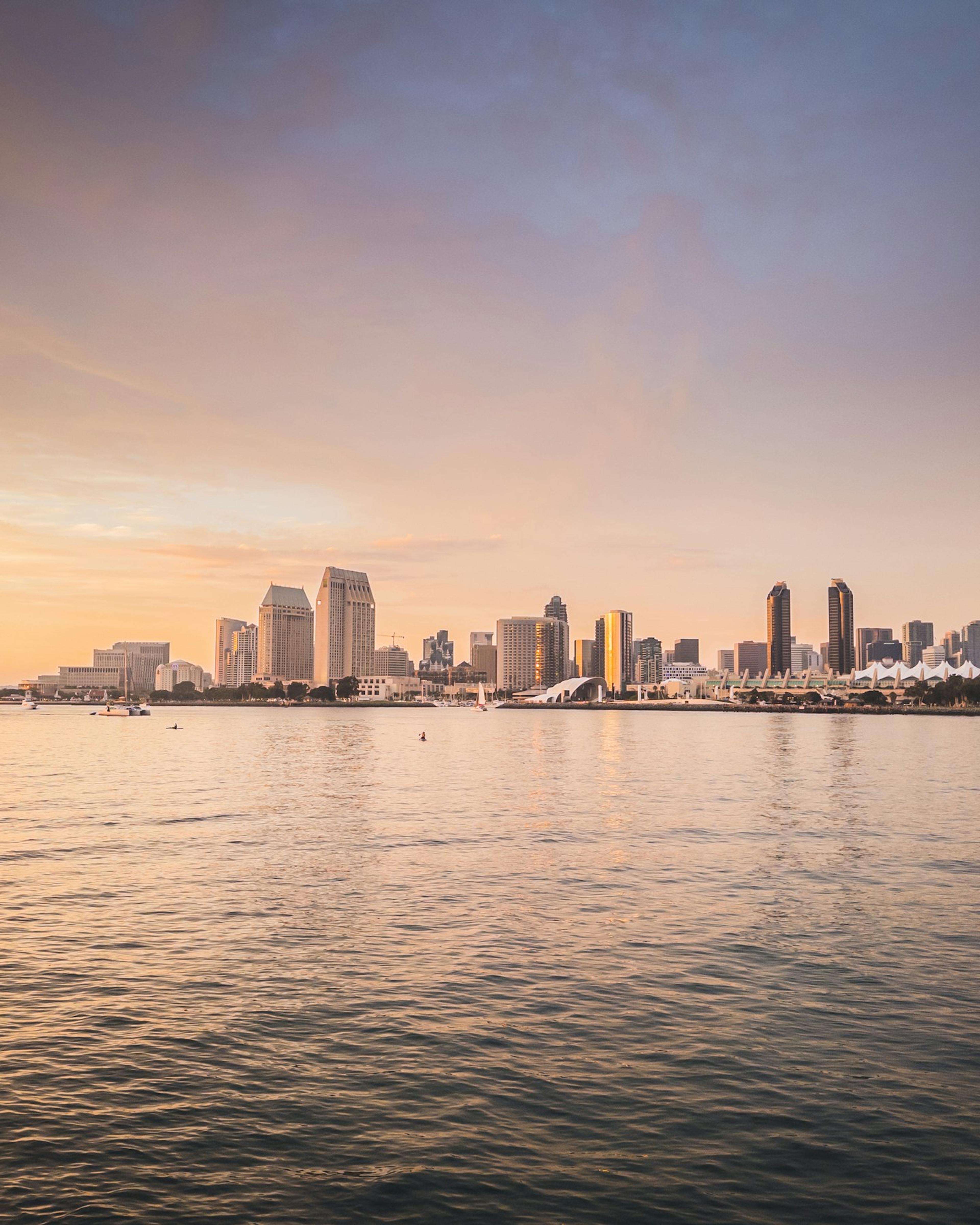 City skyline across the water at sunset