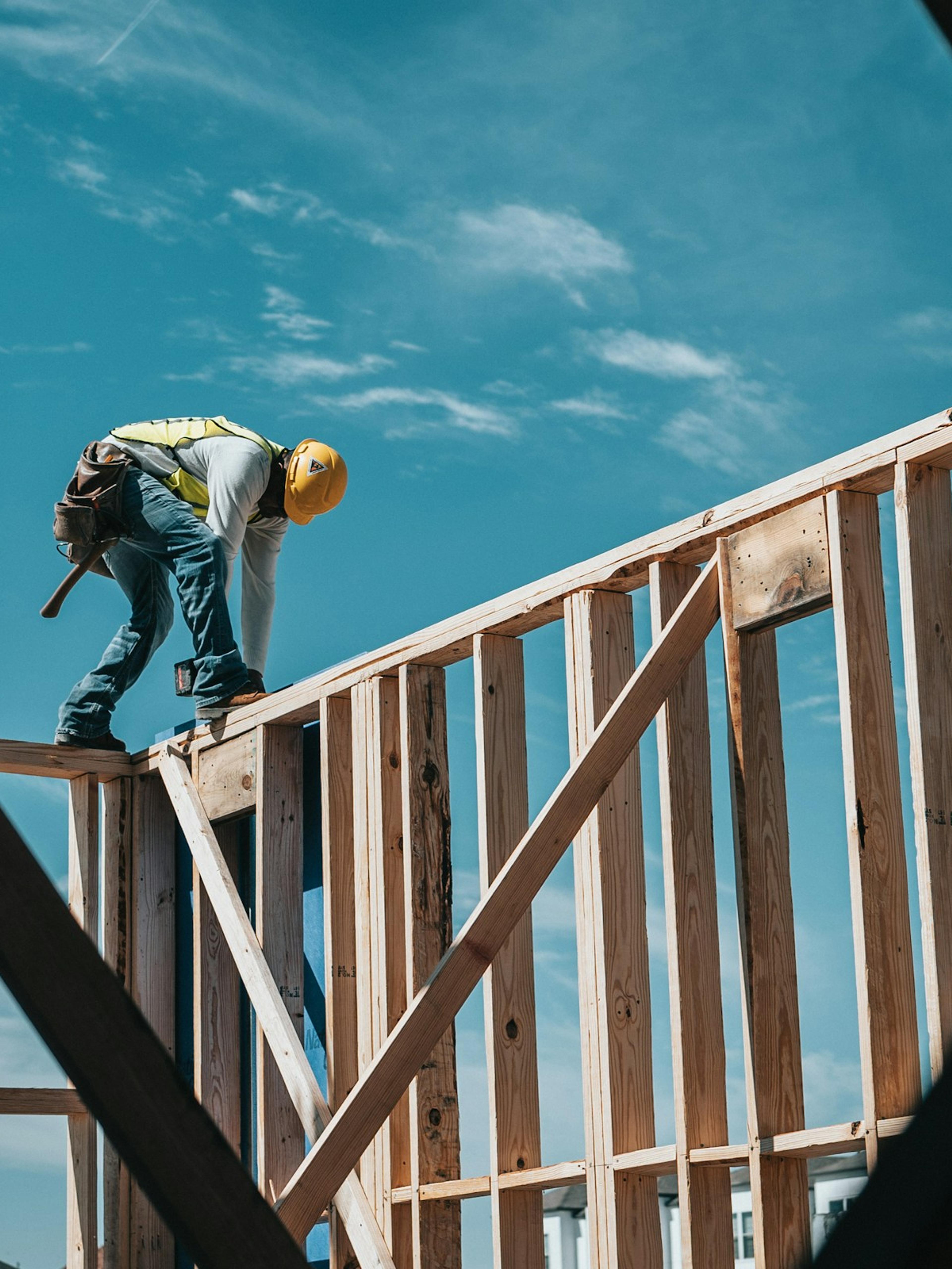 Construction worker in a hard hat on a building frame