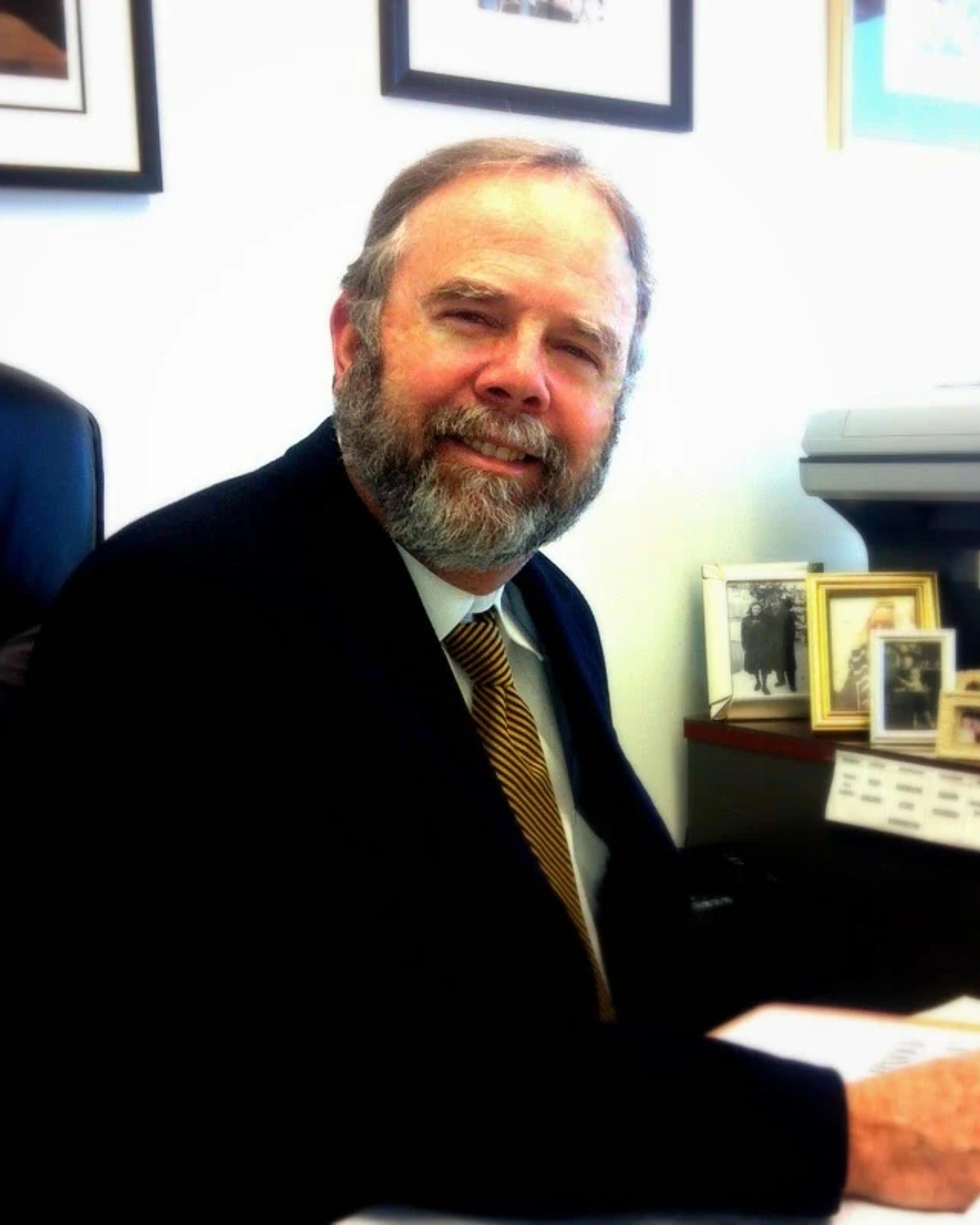 Rodolfo Weiss, San Diego workers’ compensation attorney, at a desk in the firm’s office