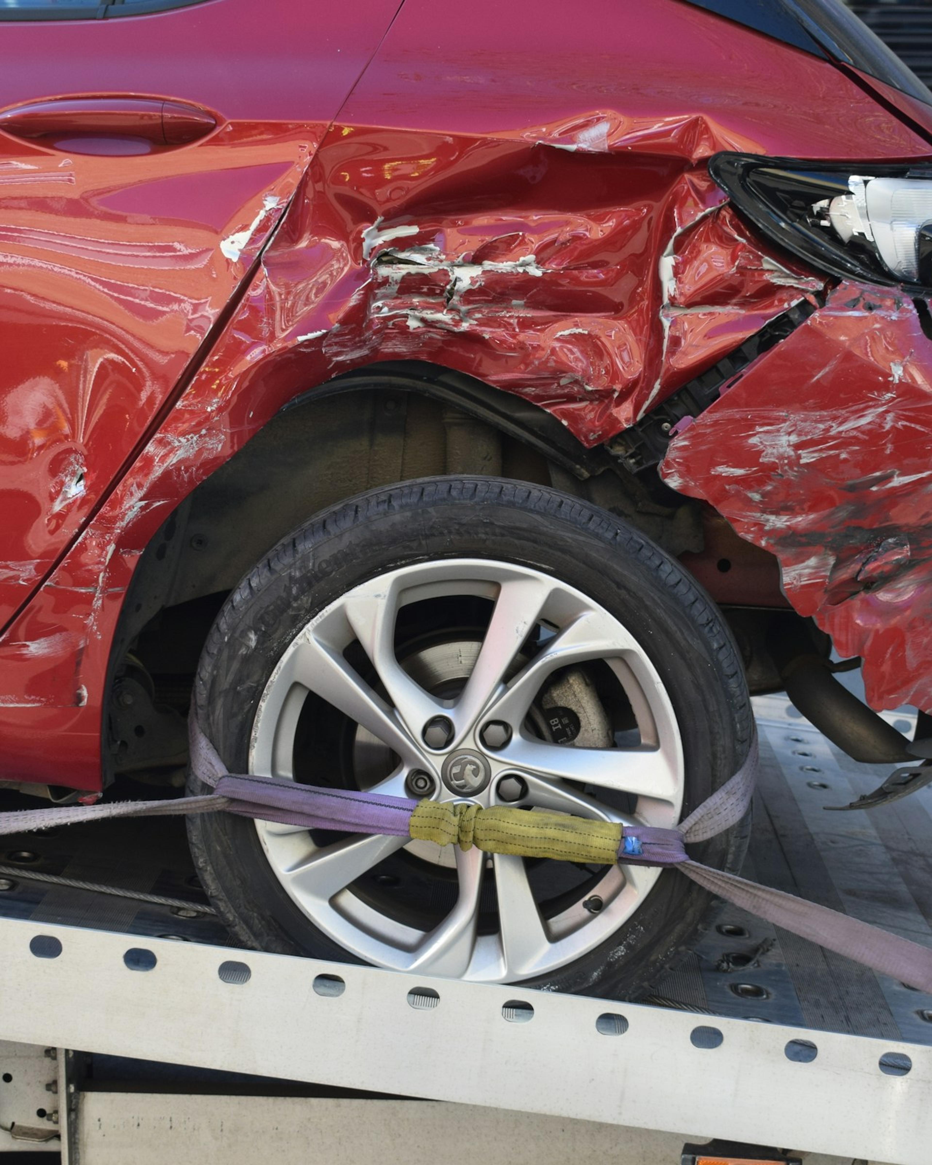Car loaded on a flatbed tow truck after an accident