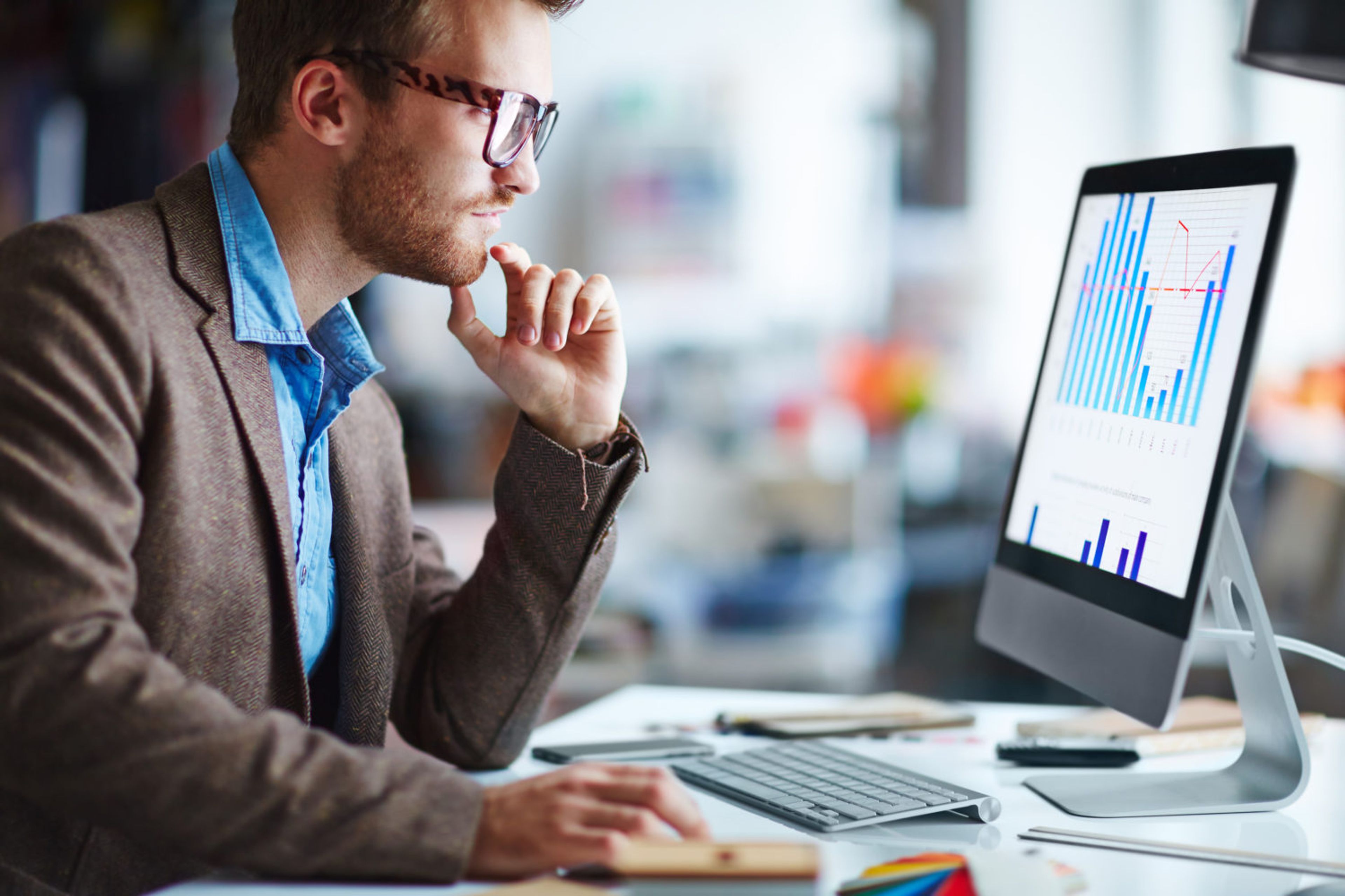 A person looking at a chart on a desktop computer