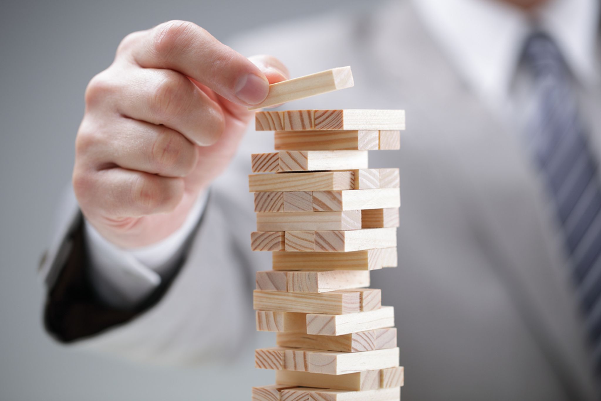 A photo of someone stacking blocks of wood on top of each other, like in the game "Jenga"