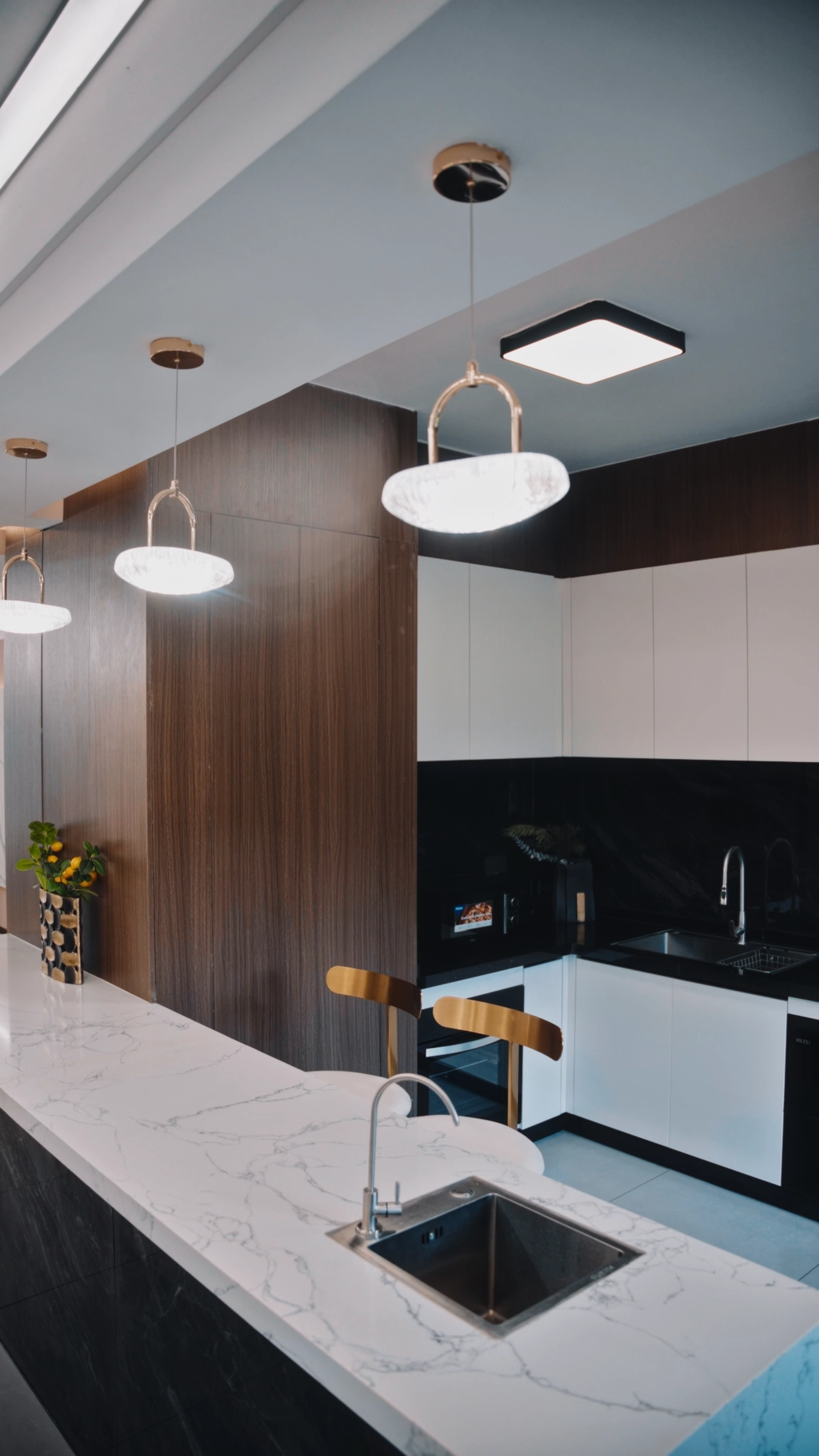 Modern kitchen with a waterfall marble island and pendant lighting