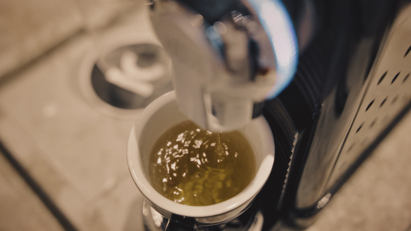 Close-up of coffee being poured into a cup