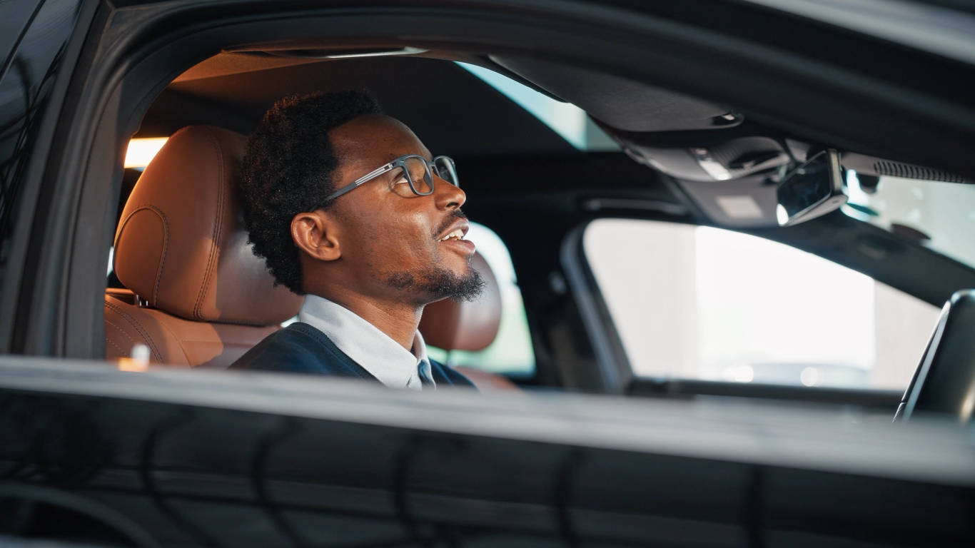 Man seated in the driver’s seat of the Mercedes