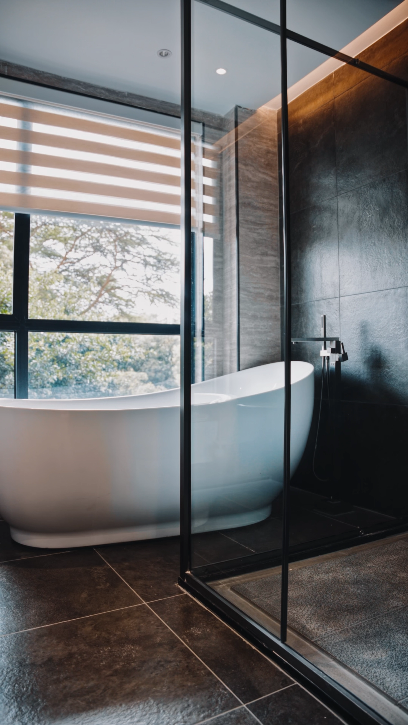 Bathroom with a freestanding tub behind a glass partition