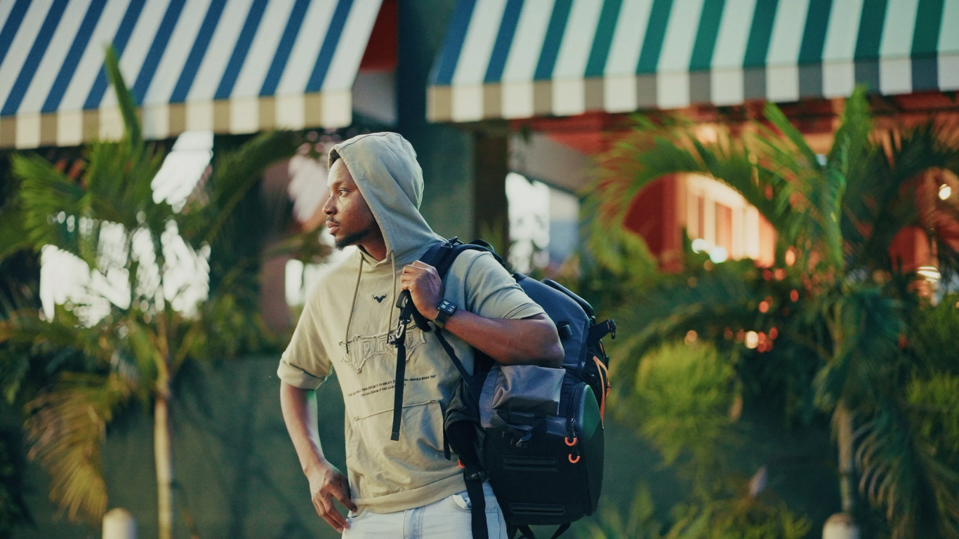 A creative walking with a camera backpack on a market street