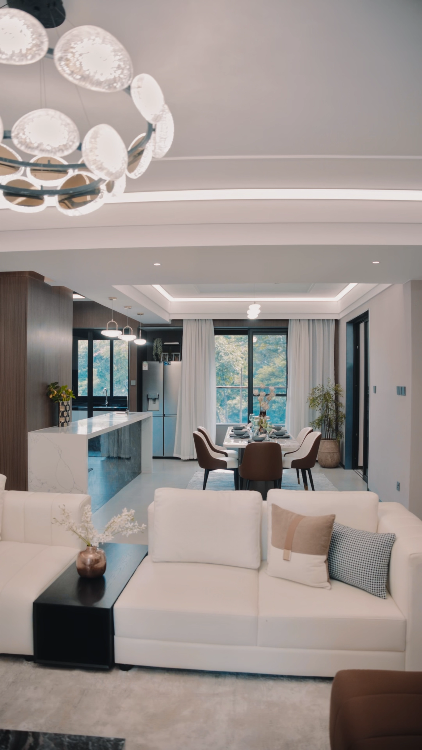 Open-plan living and dining room with large windows and contemporary furnishings