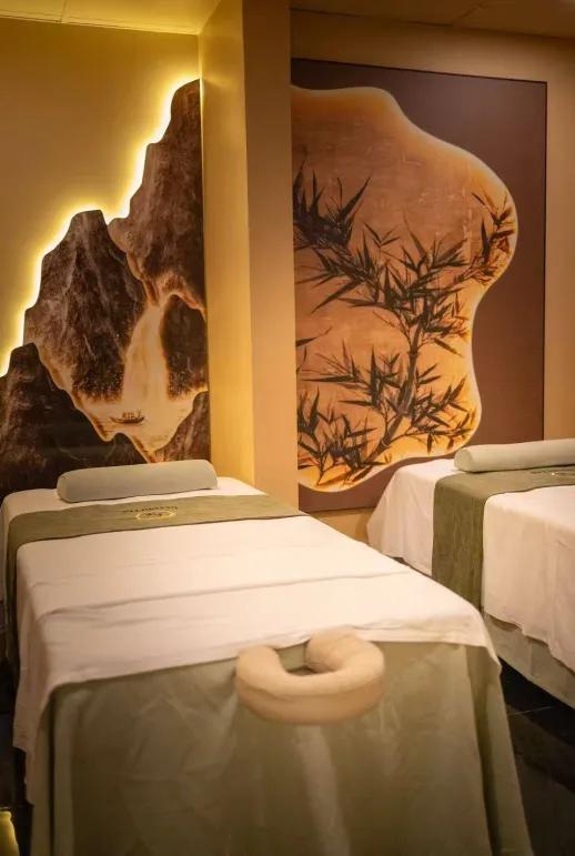 Painted mountains and bamboo enhance our couple's massage room