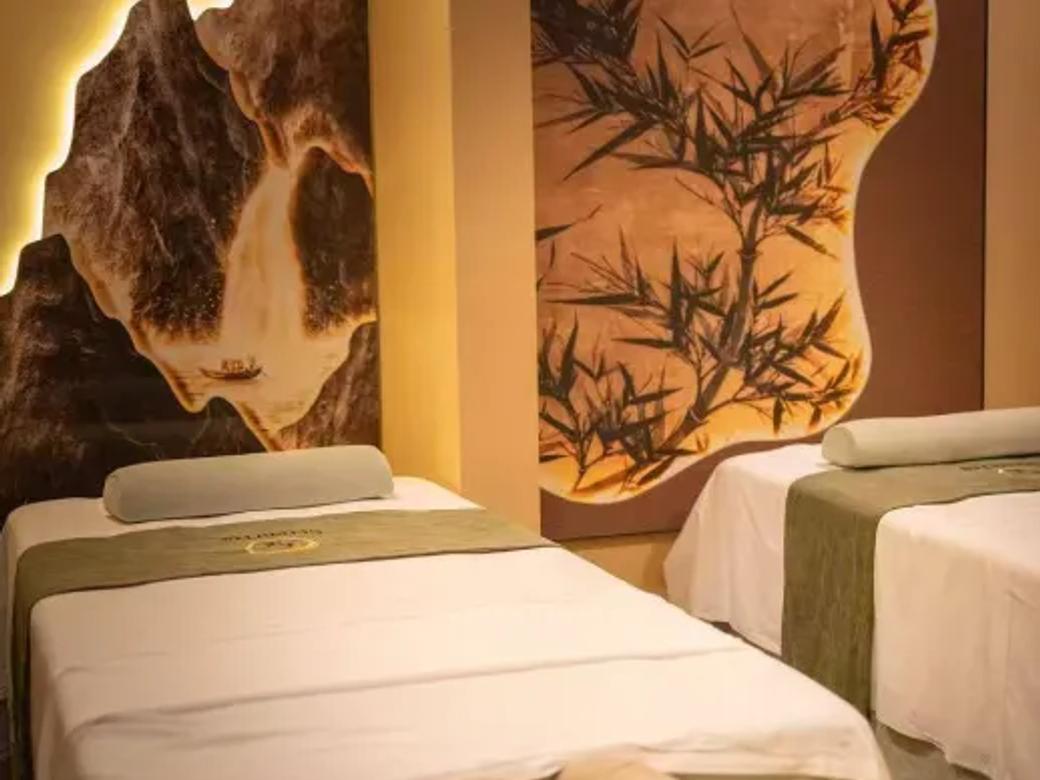 Painted mountains and bamboo enhance our couple's massage room