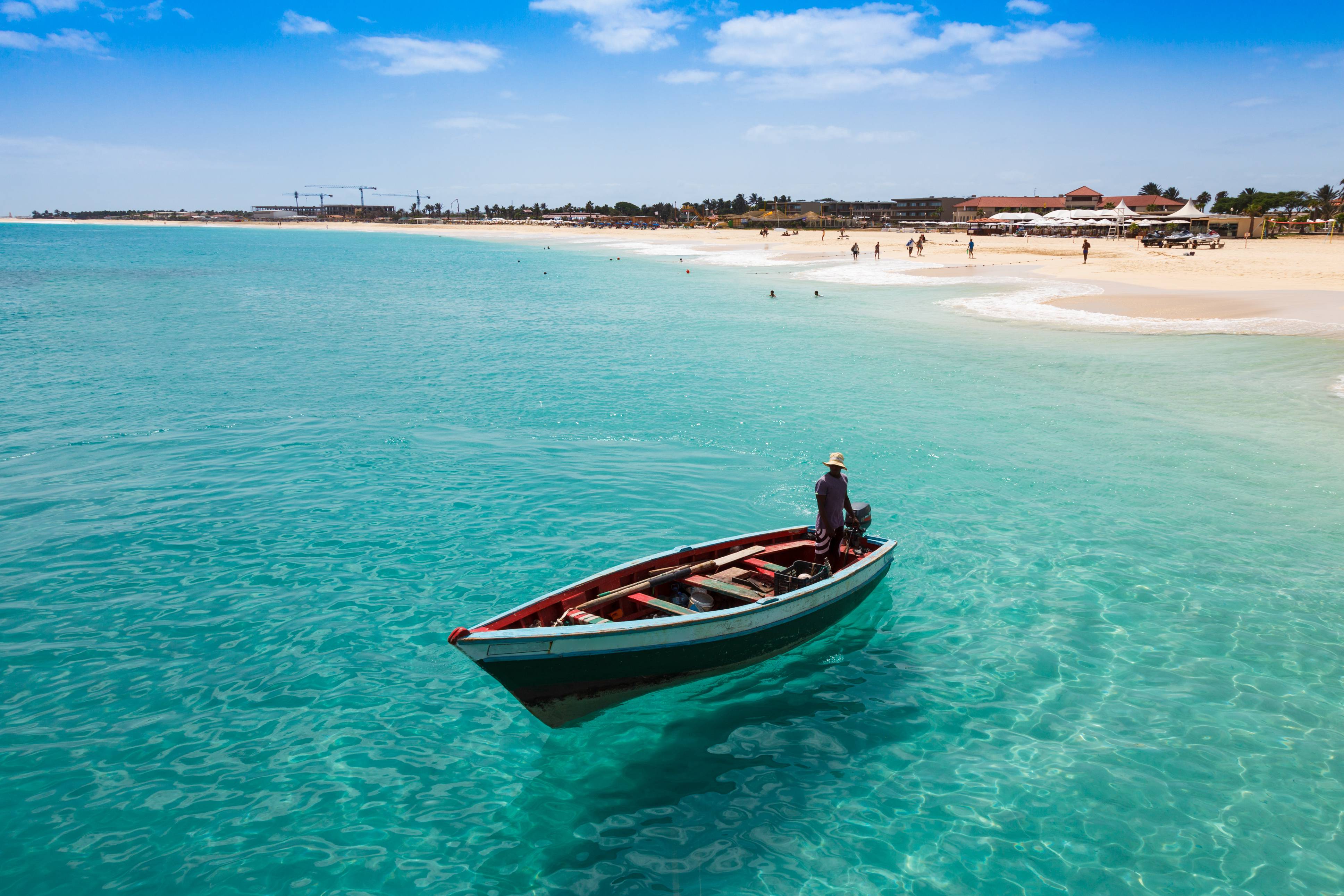 man in a boat near the beach