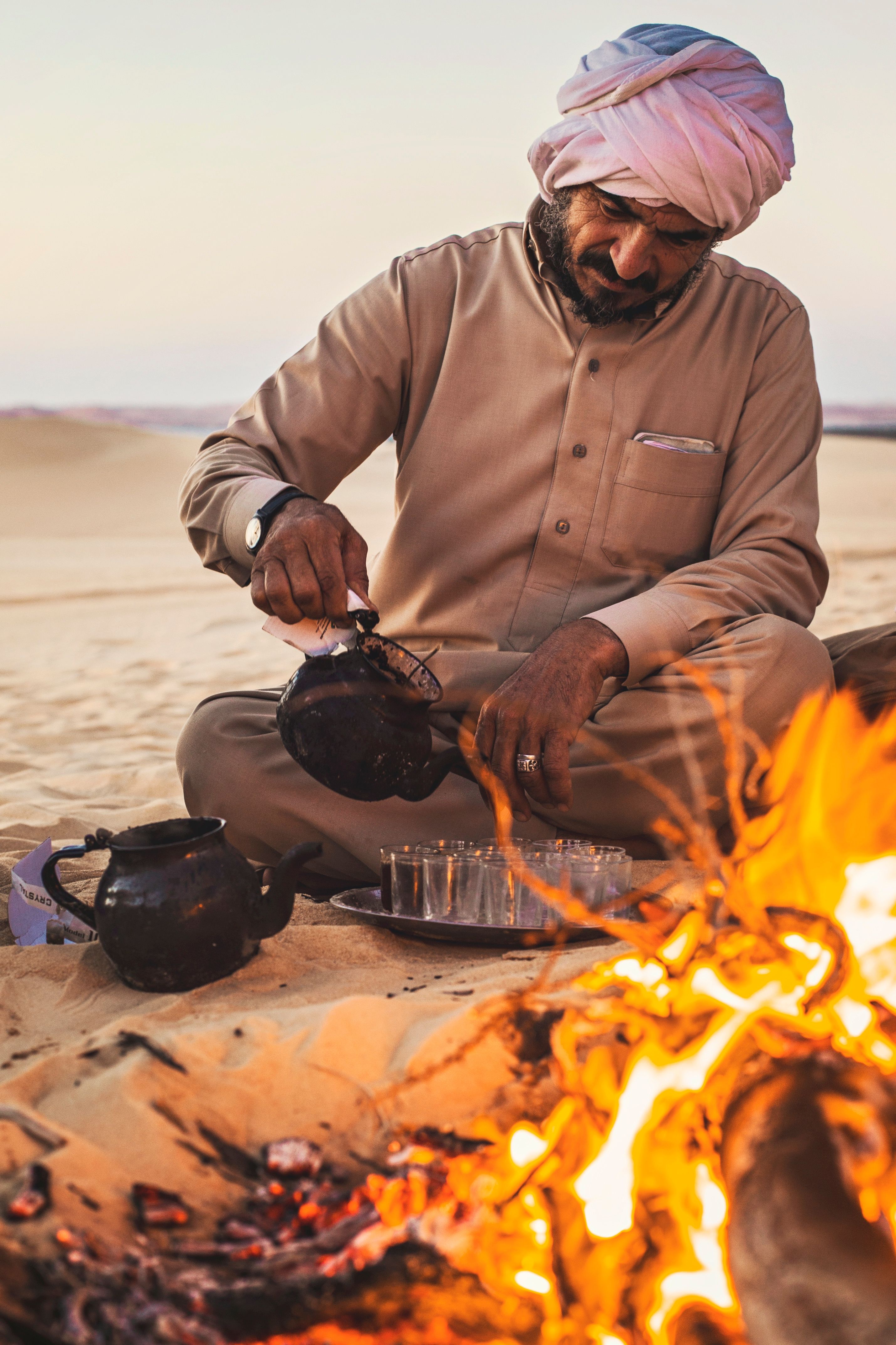 man lights a bonfire in the Sahara desert