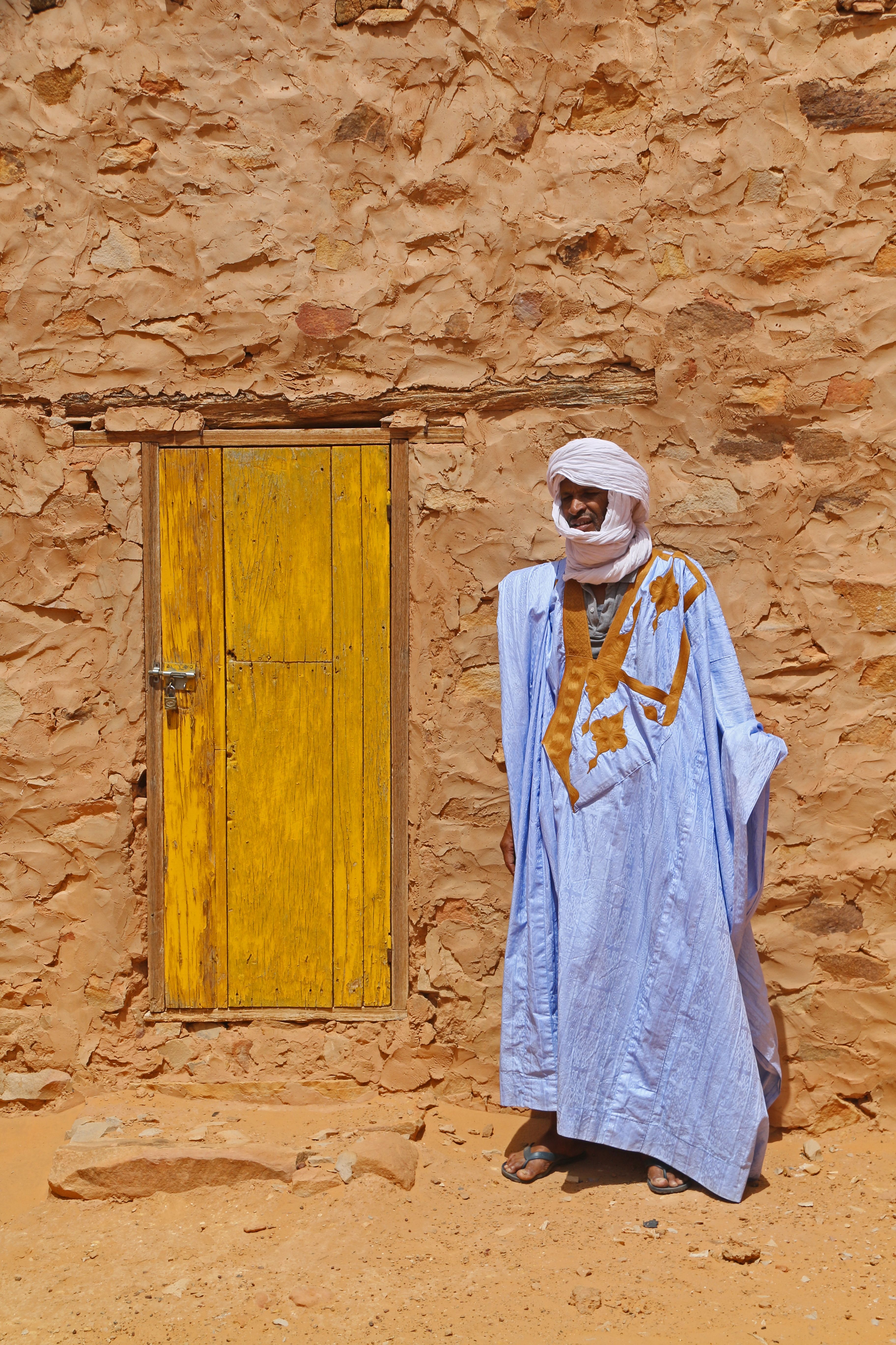 man in front of a colored door in Chinguetti