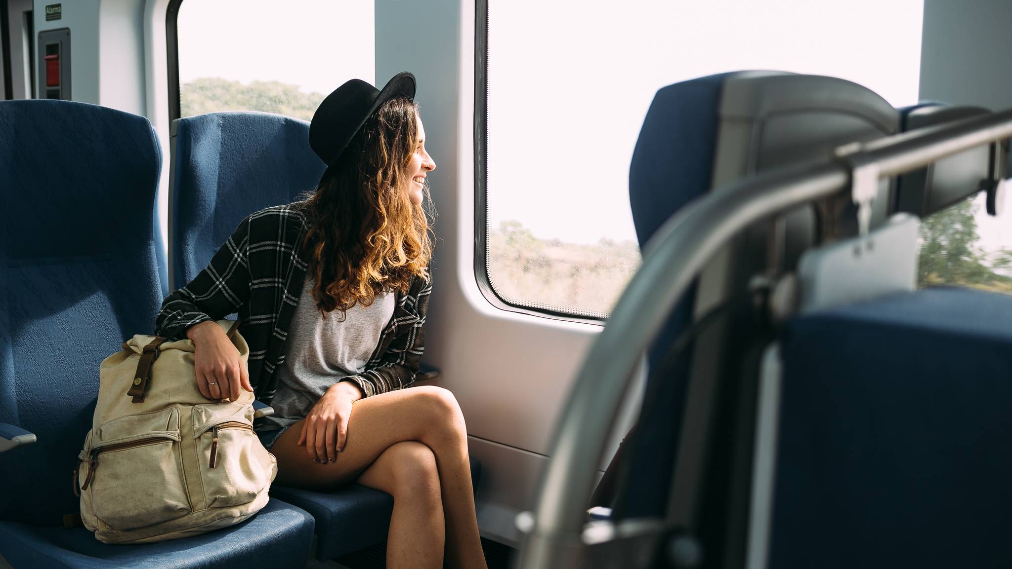 ragazza che viaggia in treno guarda fuori dal finestrino