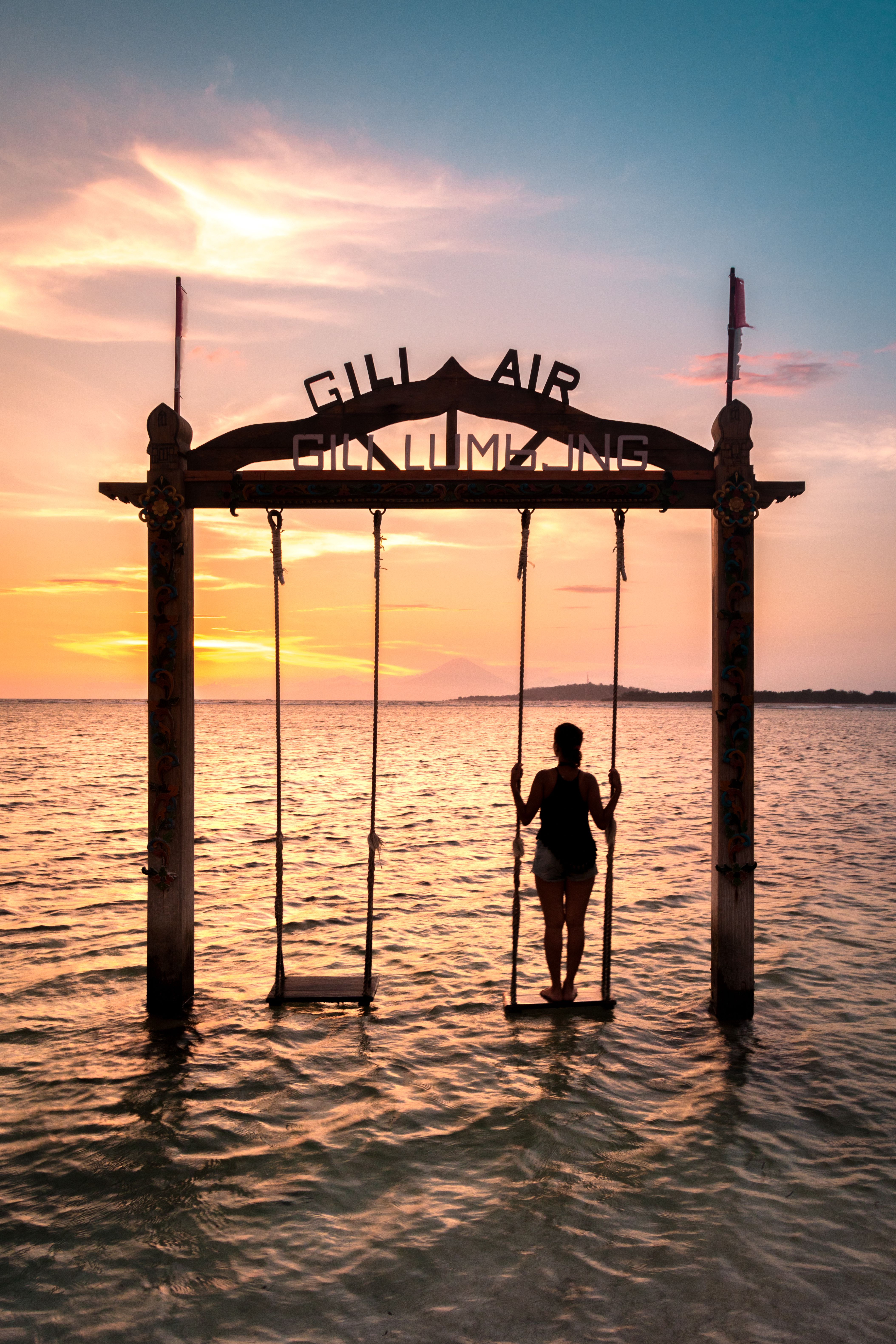 swing in the sea at sunset