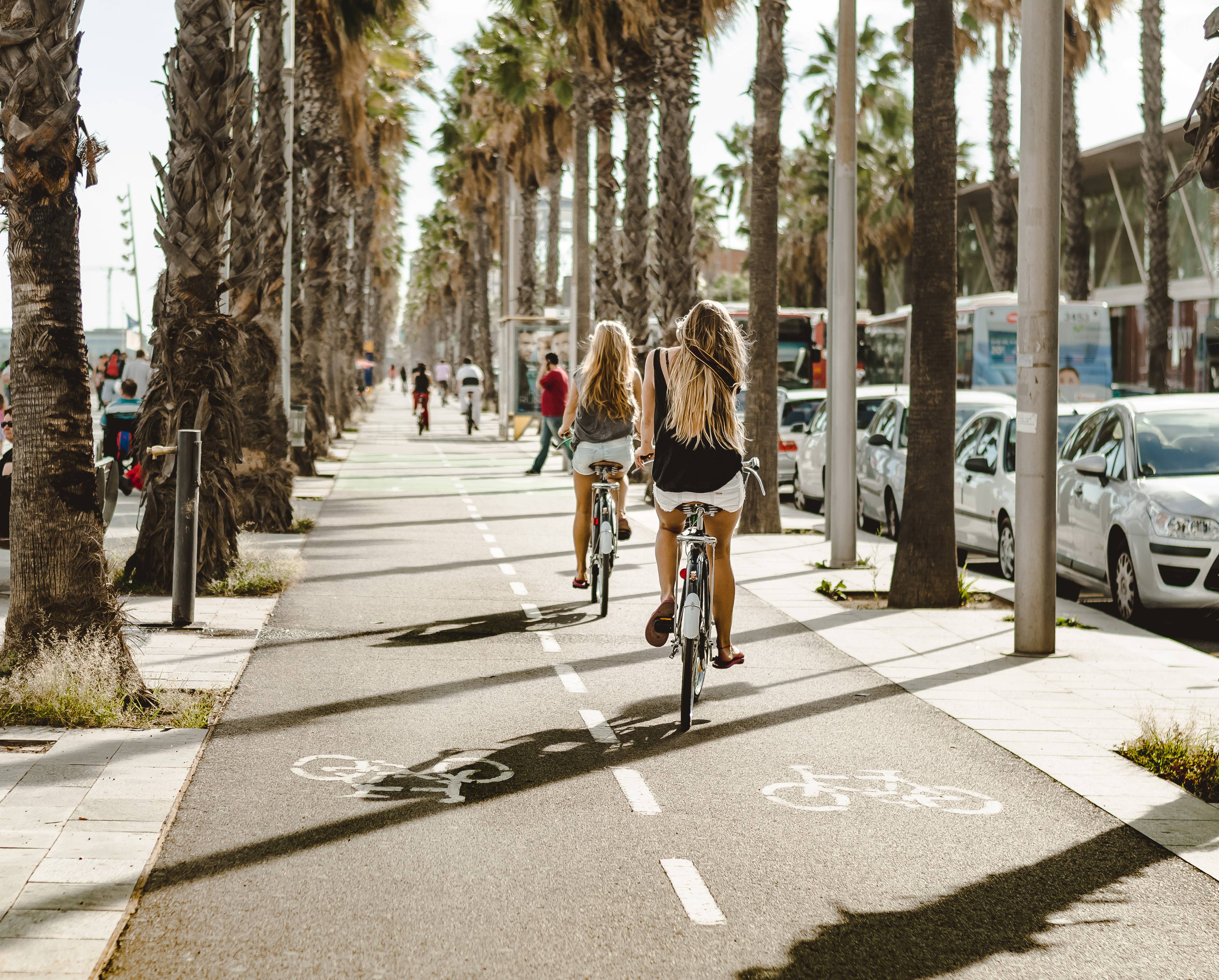 ragazze in bicicletta sul lungomare di barcellona