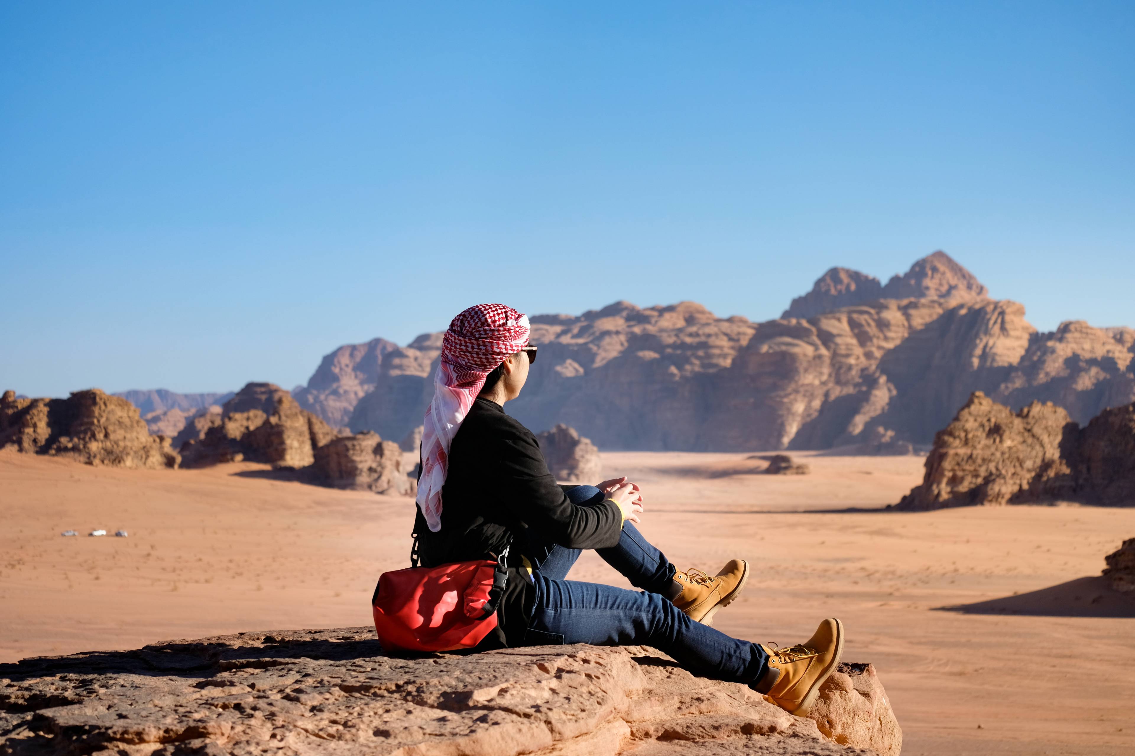 donna con kefiah nel deserto in giordania