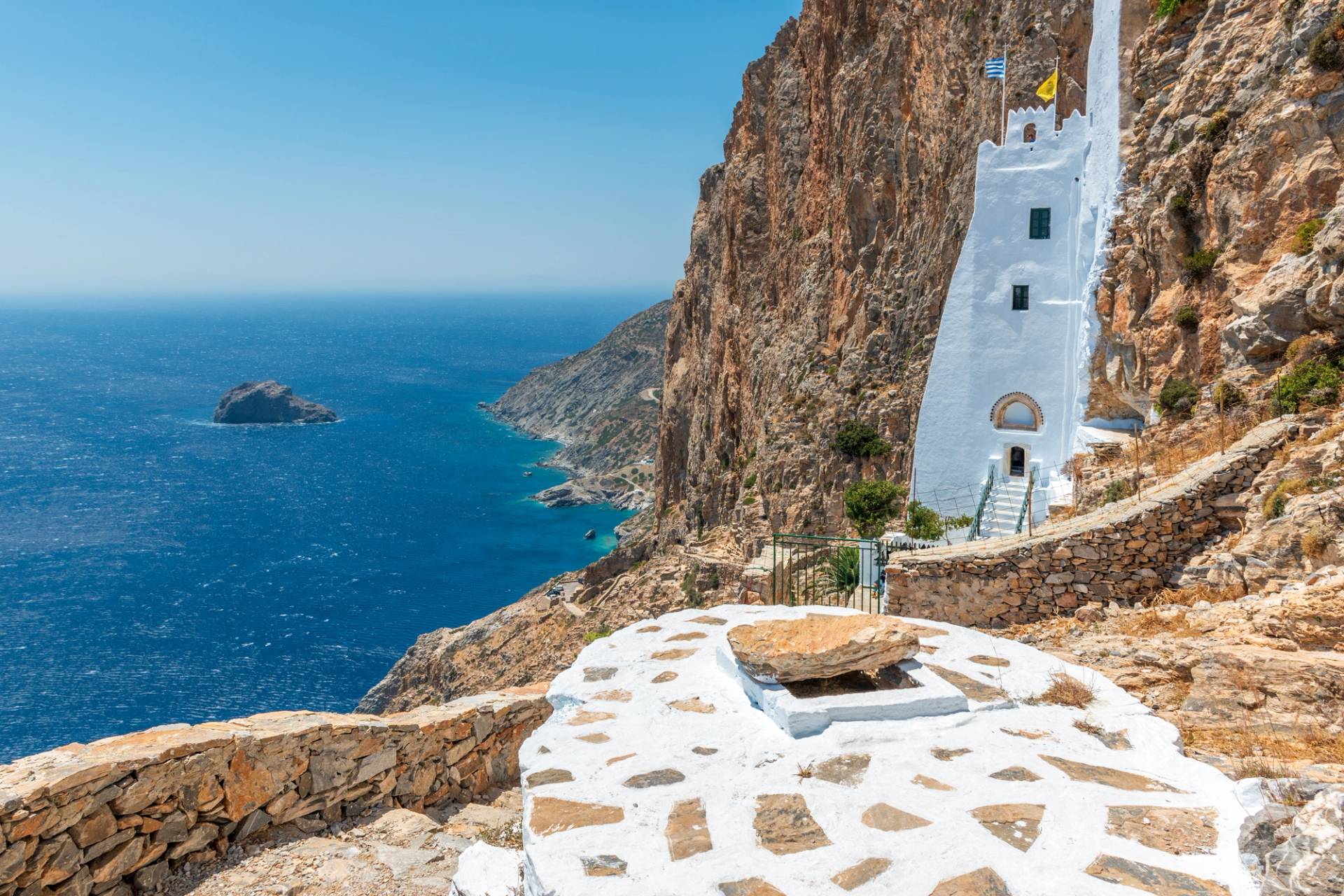 cliff with a small white house