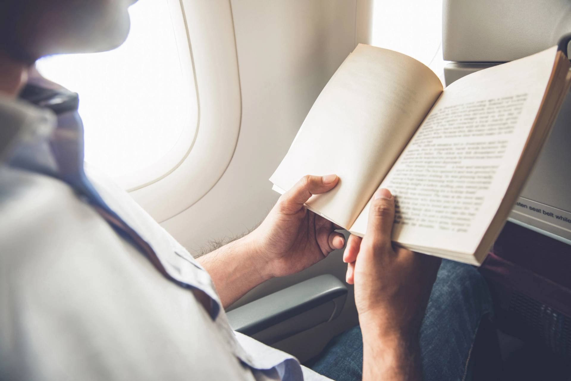passeggero che legge in aereo