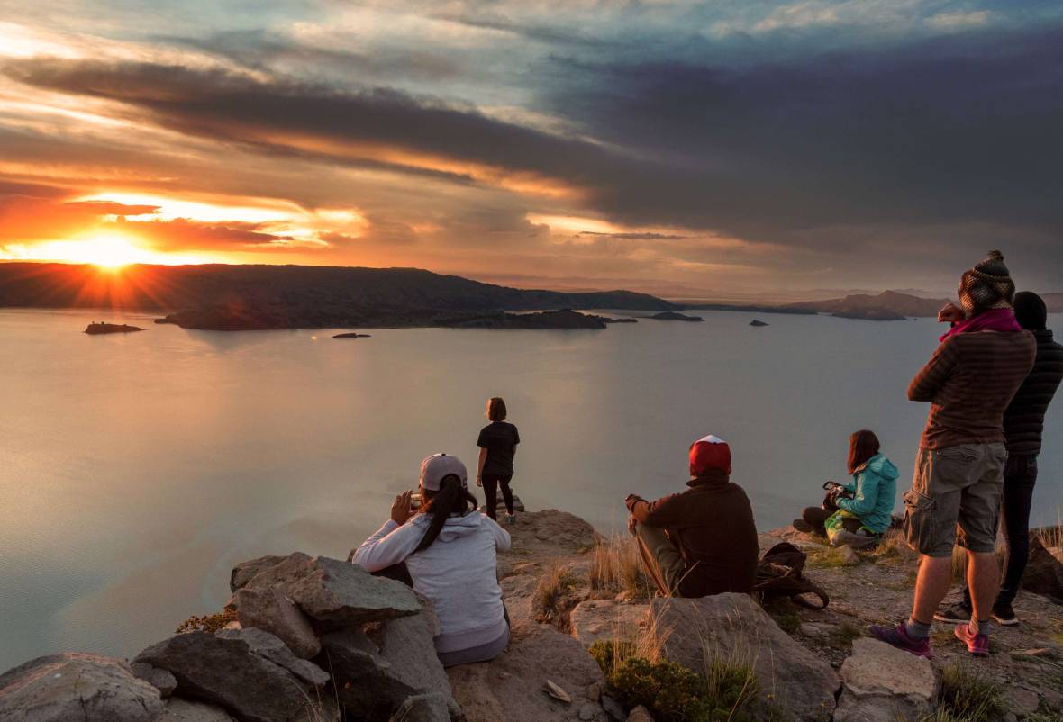 Boys watching the sunset over the sea