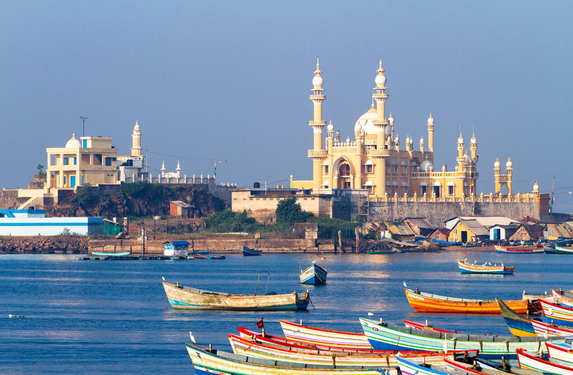 boats on river and mosque