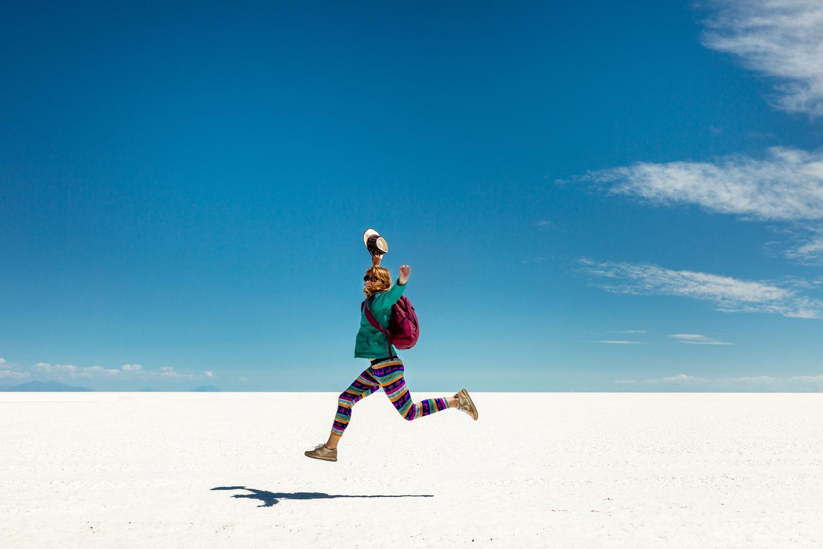 donna salta sul deserto di sale di uyuni in bolivia