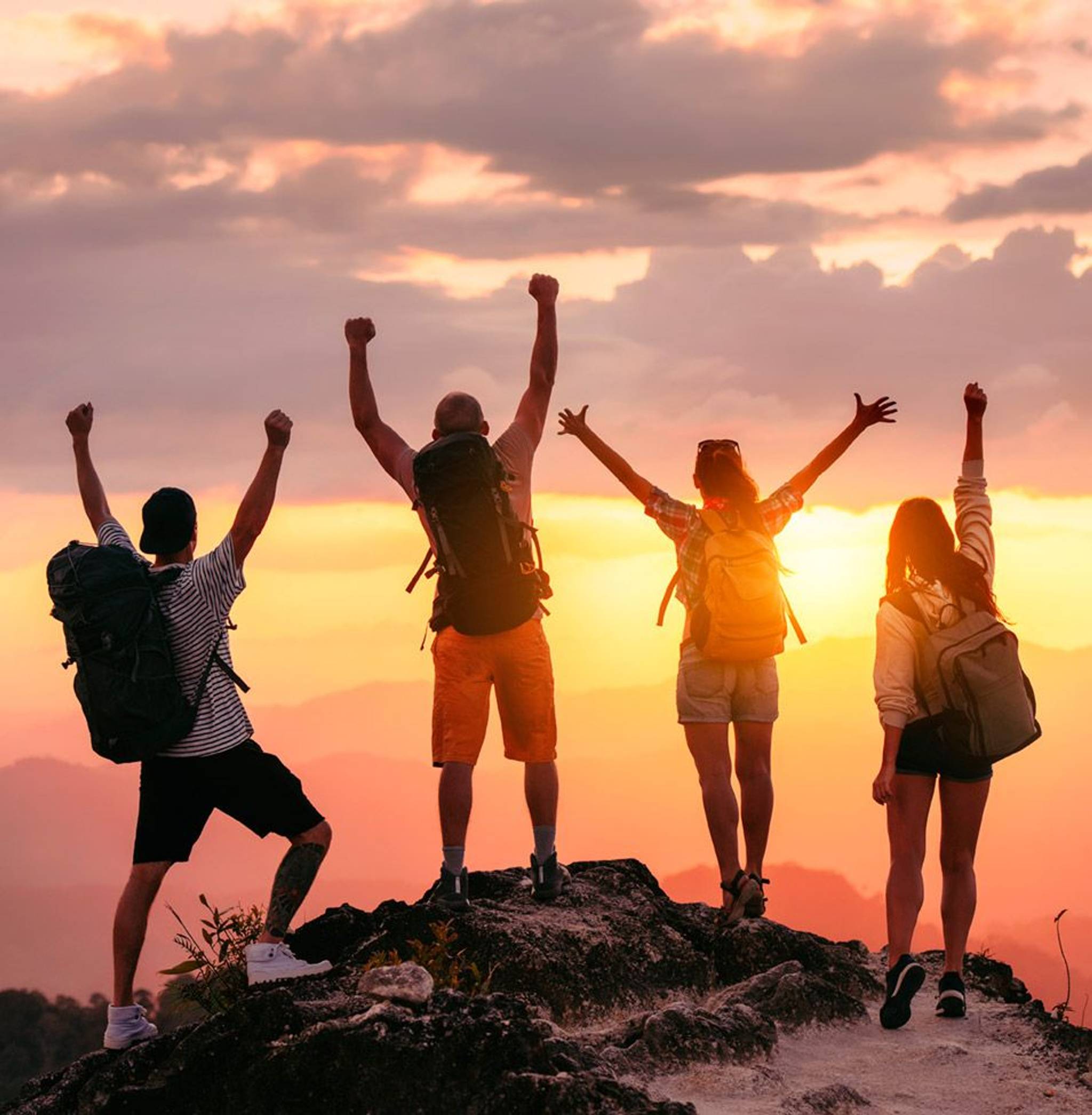 group of backpackers at sunset