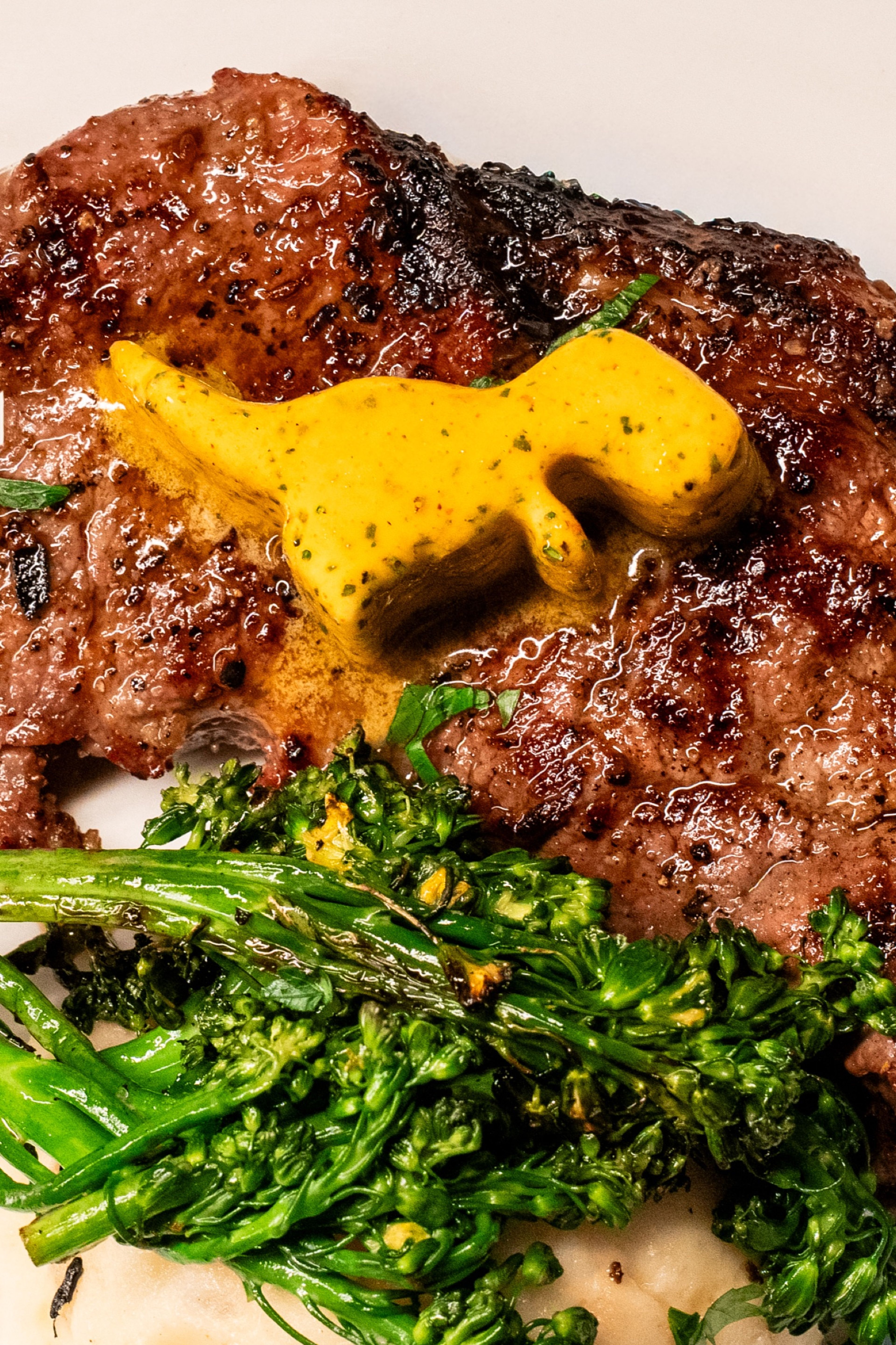Close-up of a seared steak topped with dino butter