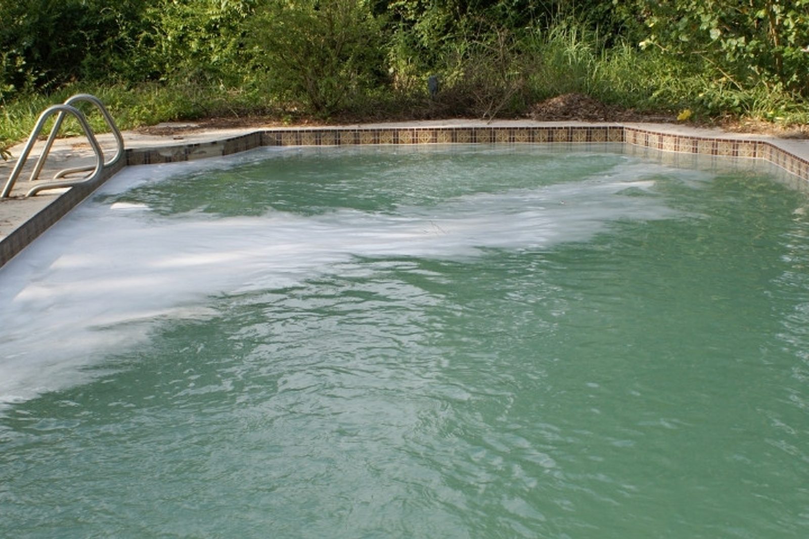 Surface foam caused by pool water contamination